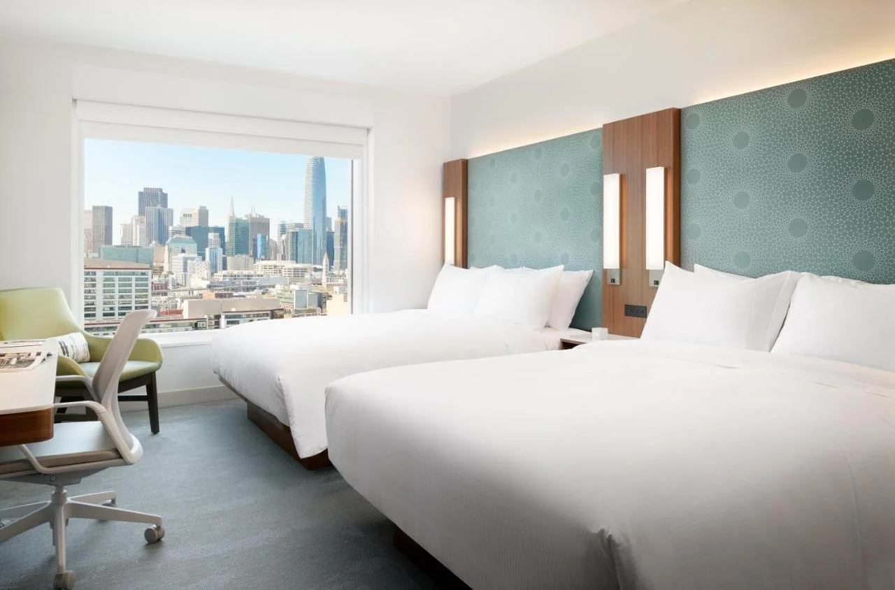 LUMA Hotel San Francisco Mission Bay guest room with San Francisco skyline view