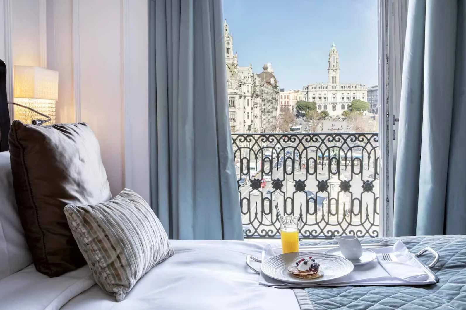 InterContinental Porto Palácio das Cardosas hotel room with balcony view of Aliados Avenue and Porto City Hall clock tower