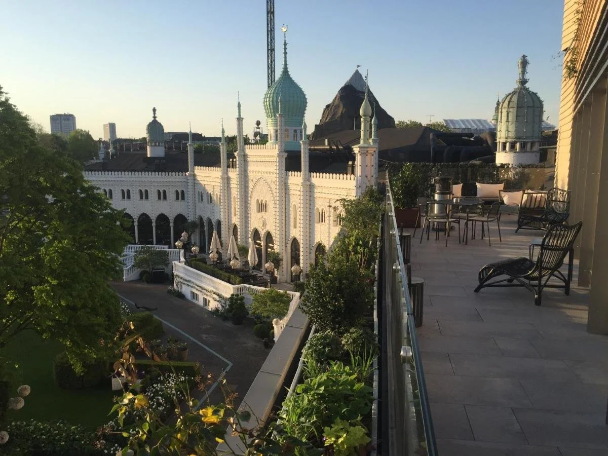 Nimb Hotel Copenhagen rooftop terrace with direct view over Tivoli Gardens Moorish palace, arches, and copper dome minarets