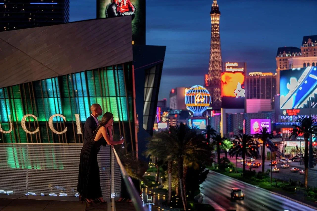 Waldorf Astoria Las Vegas outdoor terrace at night overlooking the Strip with the Paris Las Vegas Eiffel Tower replica and neon signs below