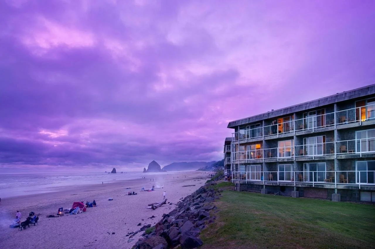 Tolovana Inn Cannon Beach beachfront hotel facade with pink sky