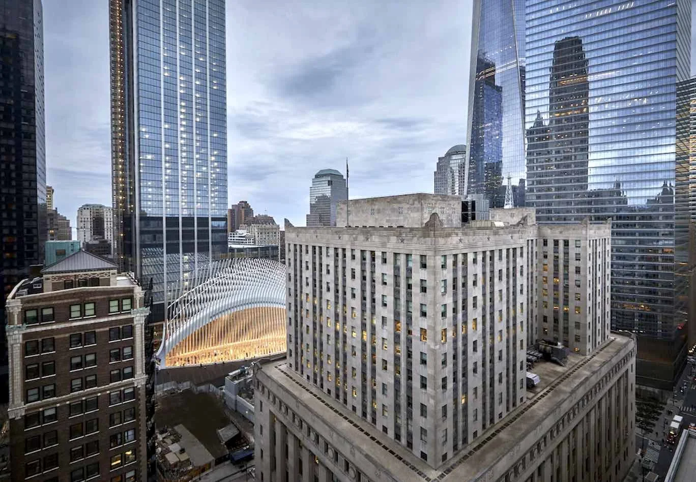 Four Seasons Hotel New York Downtown exterior view with Oculus transit hub and One World Trade Center in Tribeca