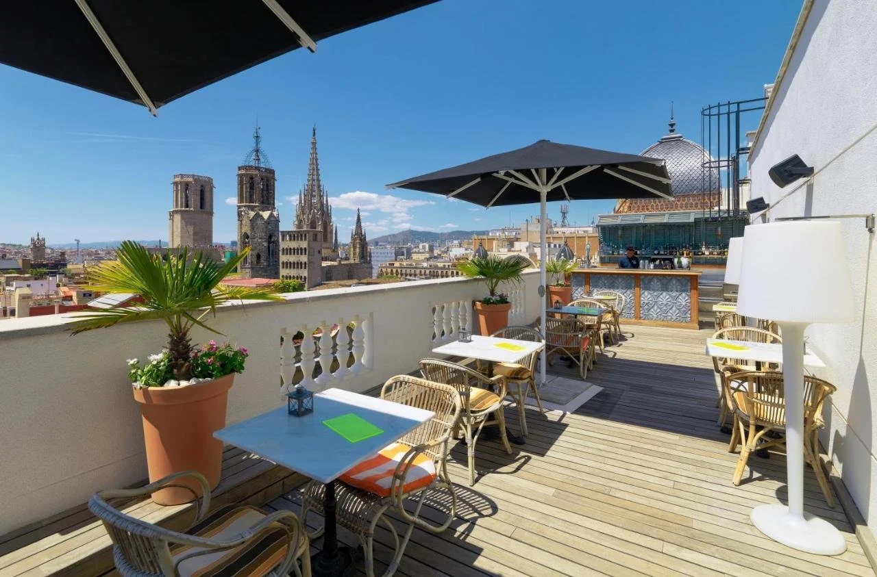 Boutique Hotel H10 Montcada Barcelona rooftop terrace with Cathedral of Barcelona Gothic spires and historic centre rooftops