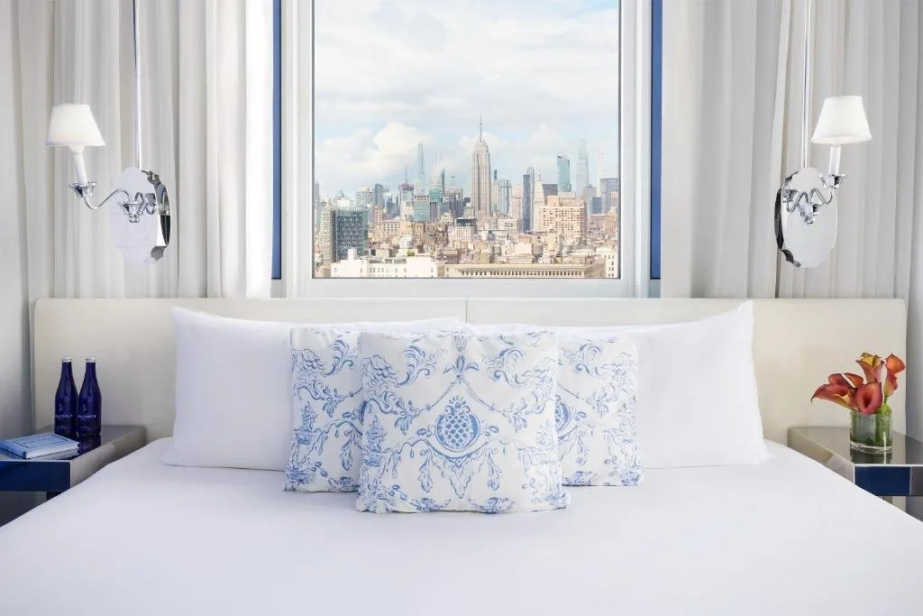 NoMo SoHo New York hotel room with Empire State Building and Midtown skyline through bedroom window