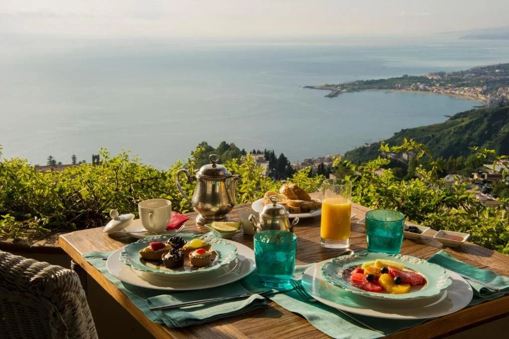 Hotel Villa Ducale Taormina breakfast terrace with panoramic view of Giardini Naxos Bay and Ionian Sea
