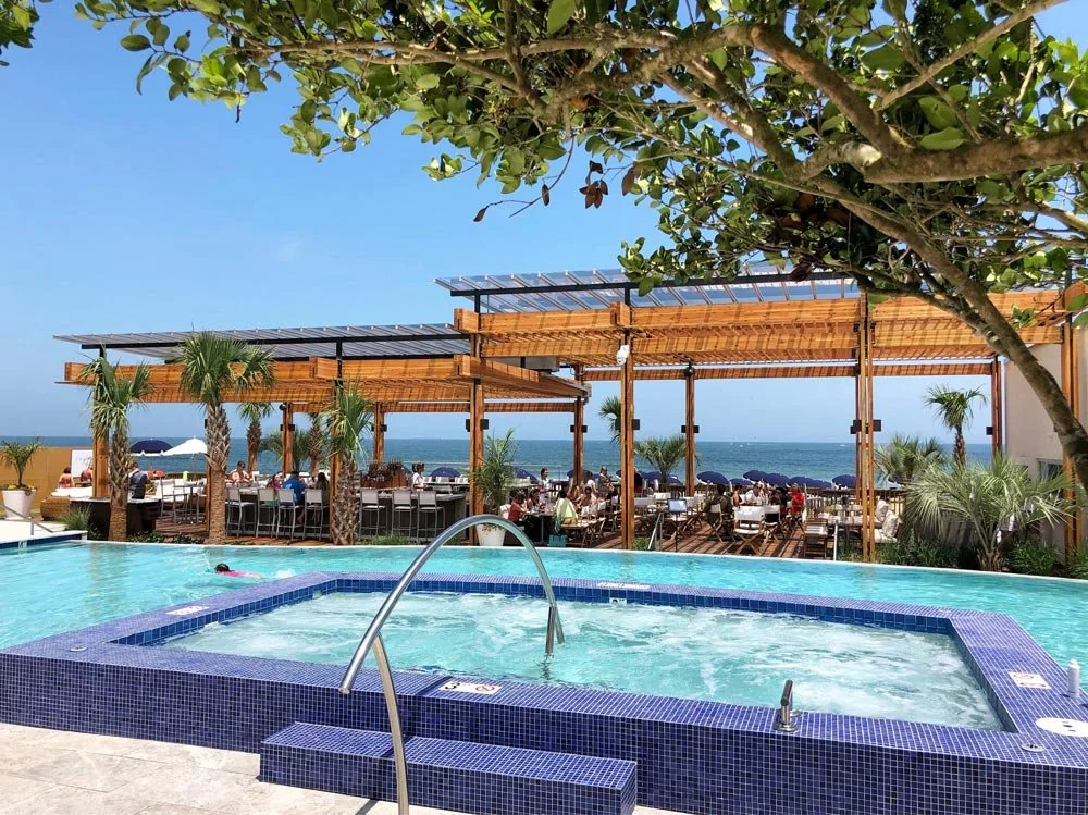 The Historic Cavalier Hotel and Beach Club Virginia Beach pool terrace with hot tub, oceanfront dining pergola, and Atlantic Ocean view