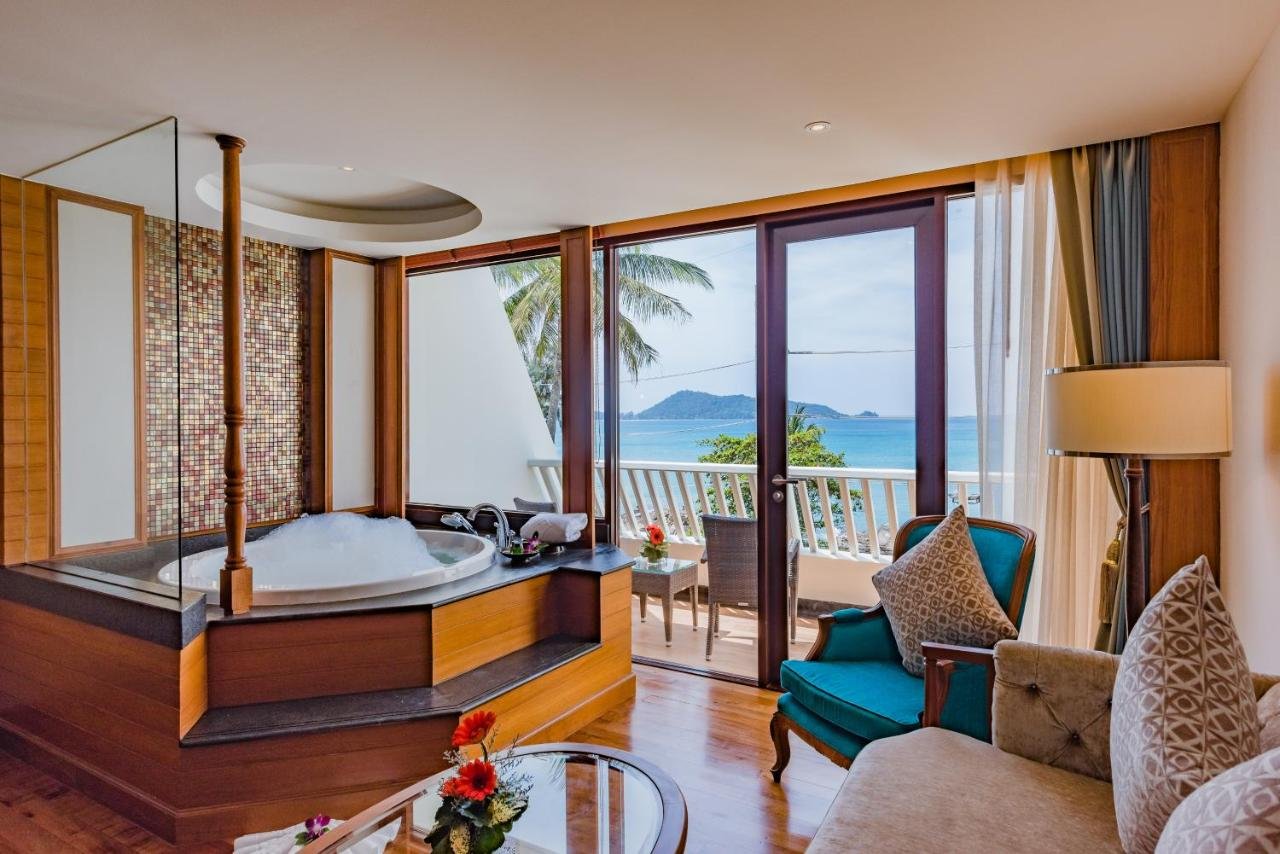 Diamond Cliff Resort Spa Phuket room with raised corner jacuzzi and balcony overlooking Andaman Sea and offshore island