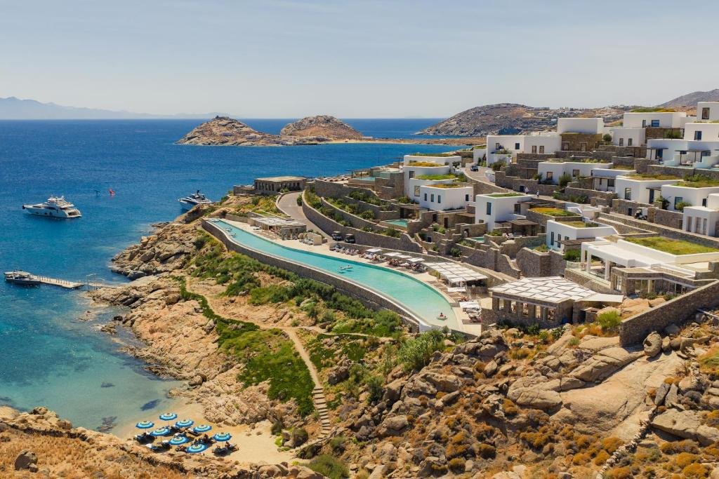 Cali Mykonos aerial view of cliffside resort with 130-metre infinity pool above private beach and Aegean Sea