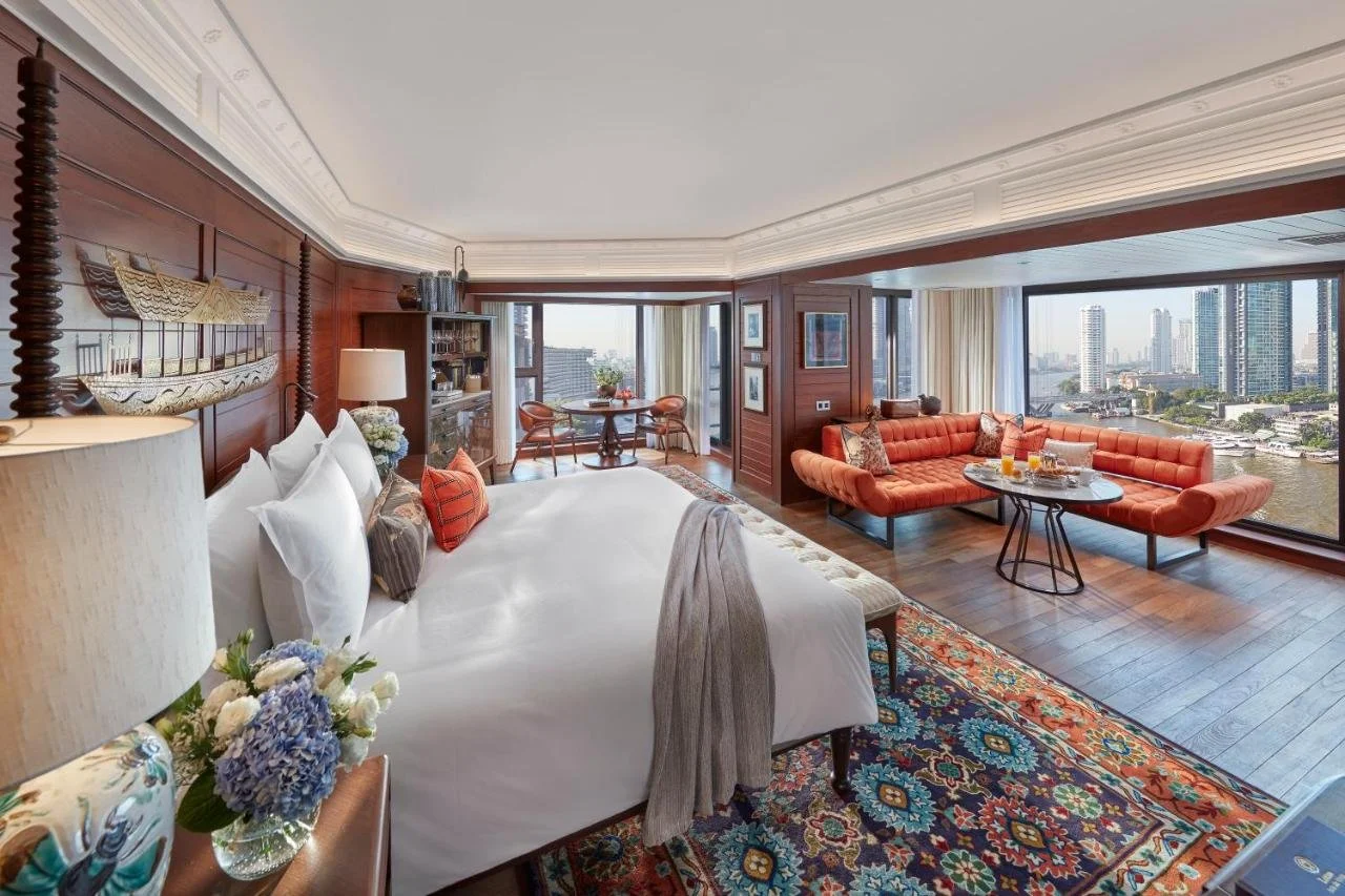 Mandarin Oriental Bangkok suite with teak wood panelling king bed and Chao Phraya River view with Bangkok skyline