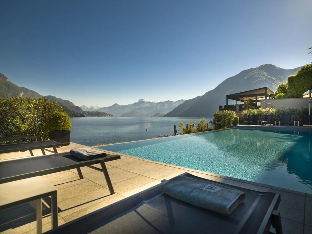 Filario Hotel and Residences Lake Como infinity pool extending over the lake toward Bellagio