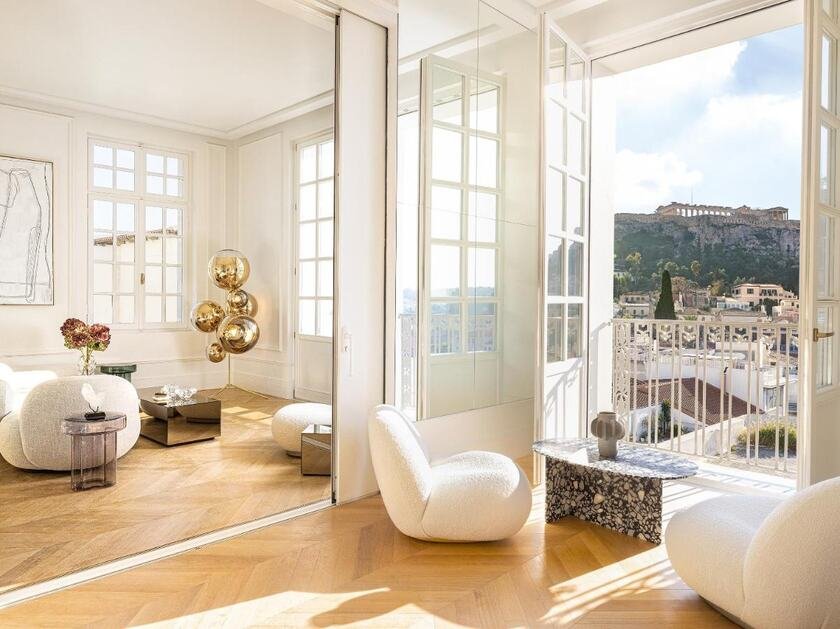 The Dolli at Acropolis Athens bright neoclassical suite with herringbone parquet and French doors open to Acropolis and Monastiraki rooftop view