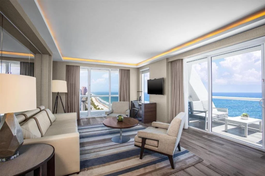 Conrad Fort Lauderdale Beach corner suite living area with wraparound Atlantic Ocean view and private balcony