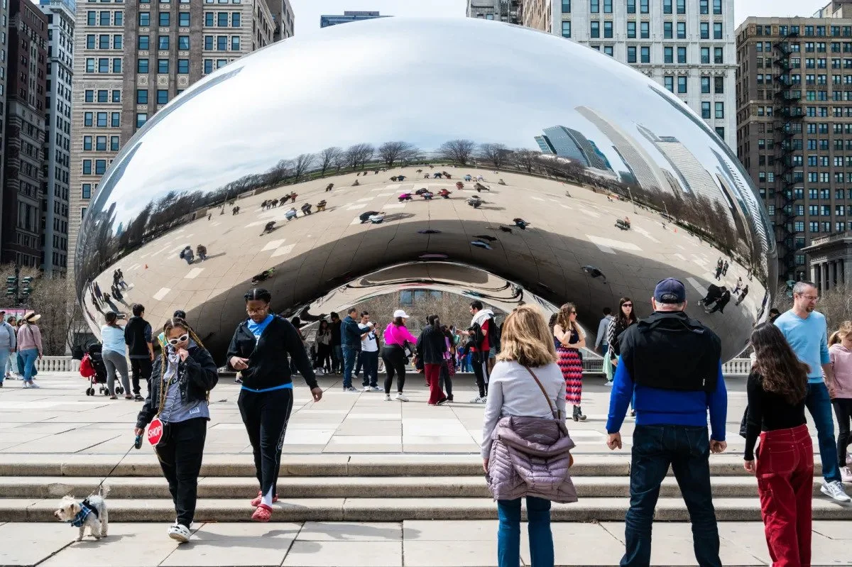 People gathered around Cloud Gate sculpture in Millennium Park, Chicago