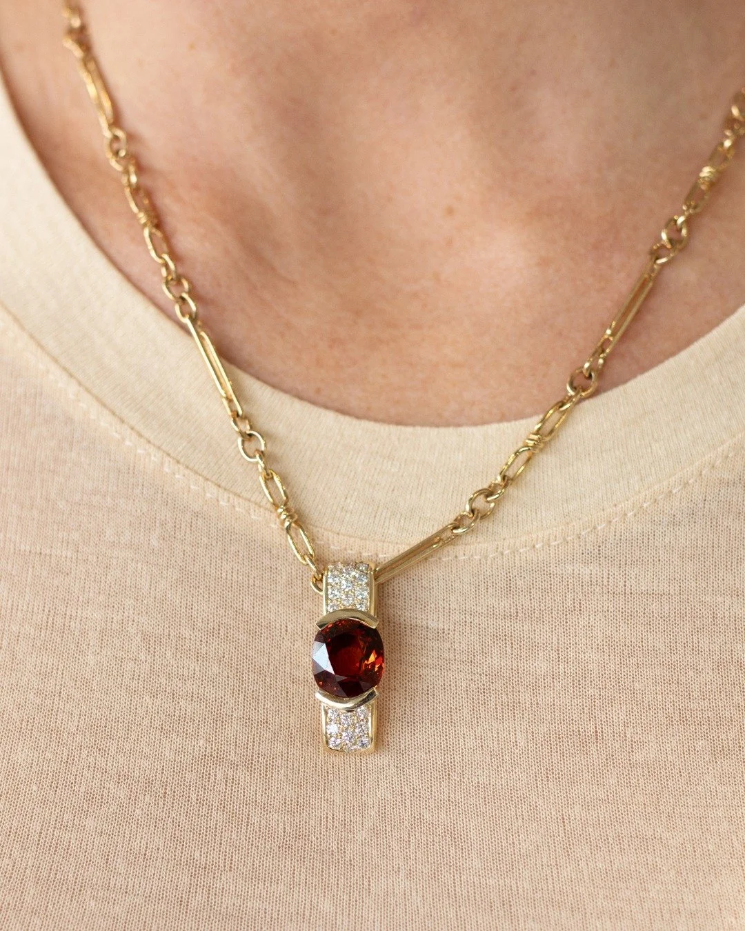 January babies, this one&rsquo;s yours. 
Garnet is January&rsquo;s birthstone. It's a symbol of strength, passion, and confidence.

Our Spessartite Garnet and Diamond Pendant brings that meaning to life, pairing the rich, fiery glow of garnet with a 