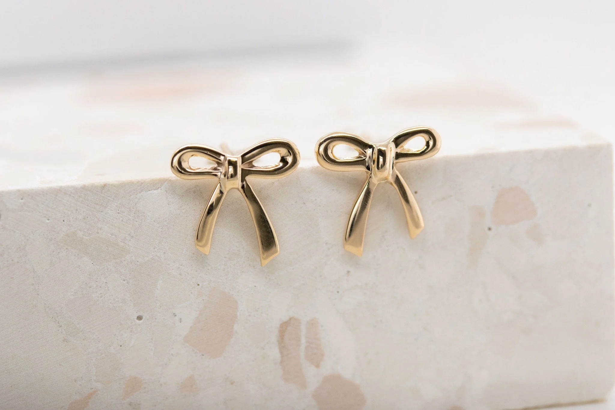 These cute bow studs are sisters, not twins! One of this much-loved pair had sadly been lost, and while no two jewellers create exactly the same, it was brought to us in the hope that we could make it a new match. And that is what we have done, so th