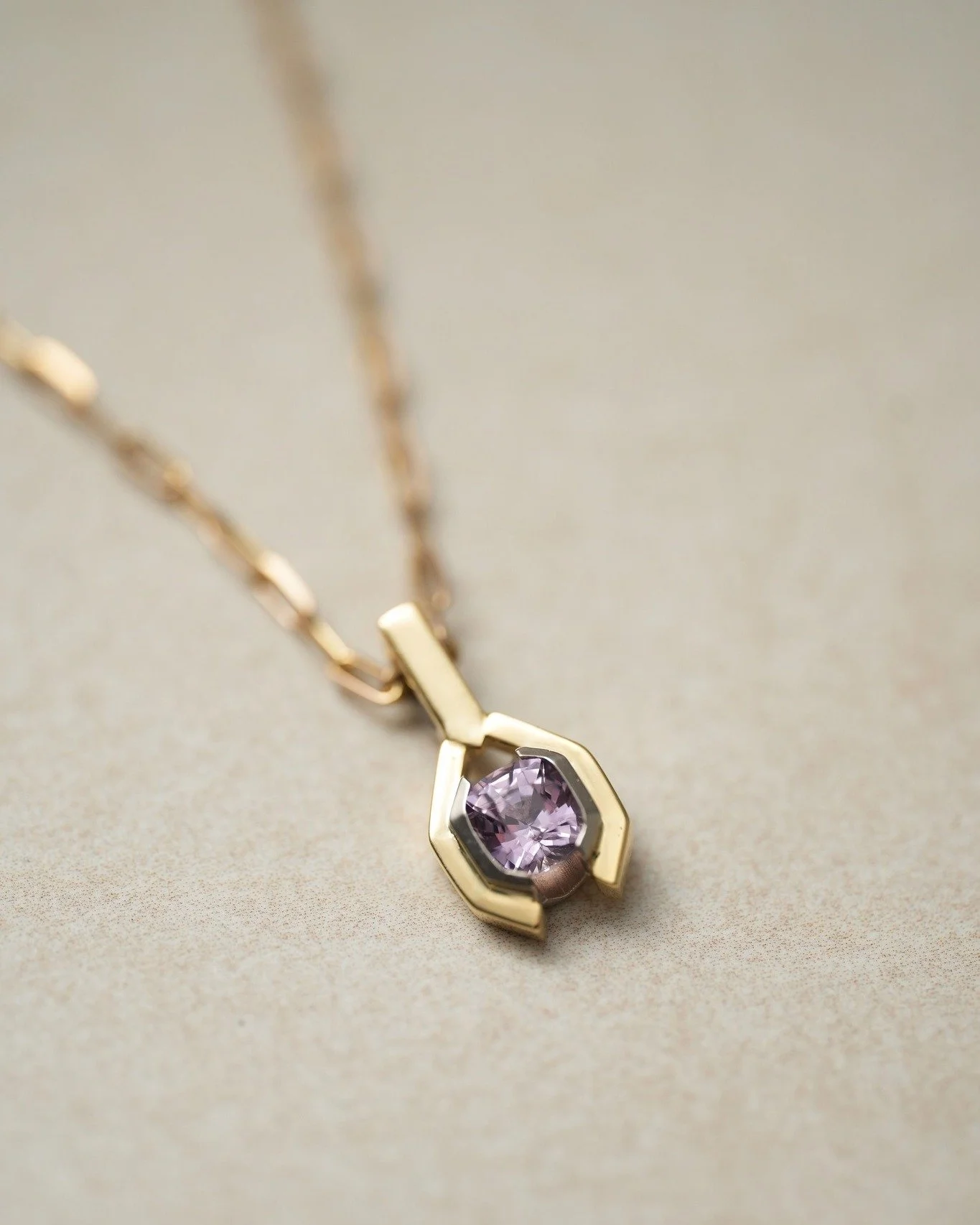 Natural Spinel is loved for its lively brilliance and is a secondary birthstone for August babies.
It comes in a plethora of colours, and this lilac beauty is a beautiful example of just one shade.
Handmade right here in yellow and white gold.

#spin