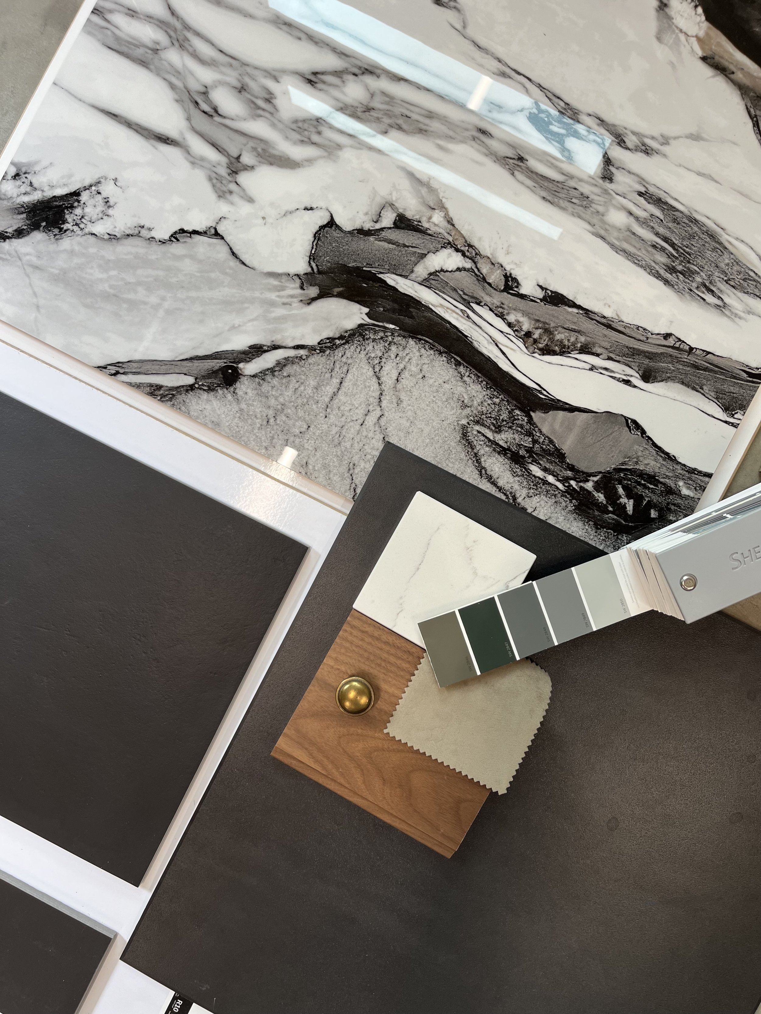 Collection of rustic tools on a wooden surface, including axes, hammers, gloves, a cup of coffee, and various tools for woodworking or metalworking.