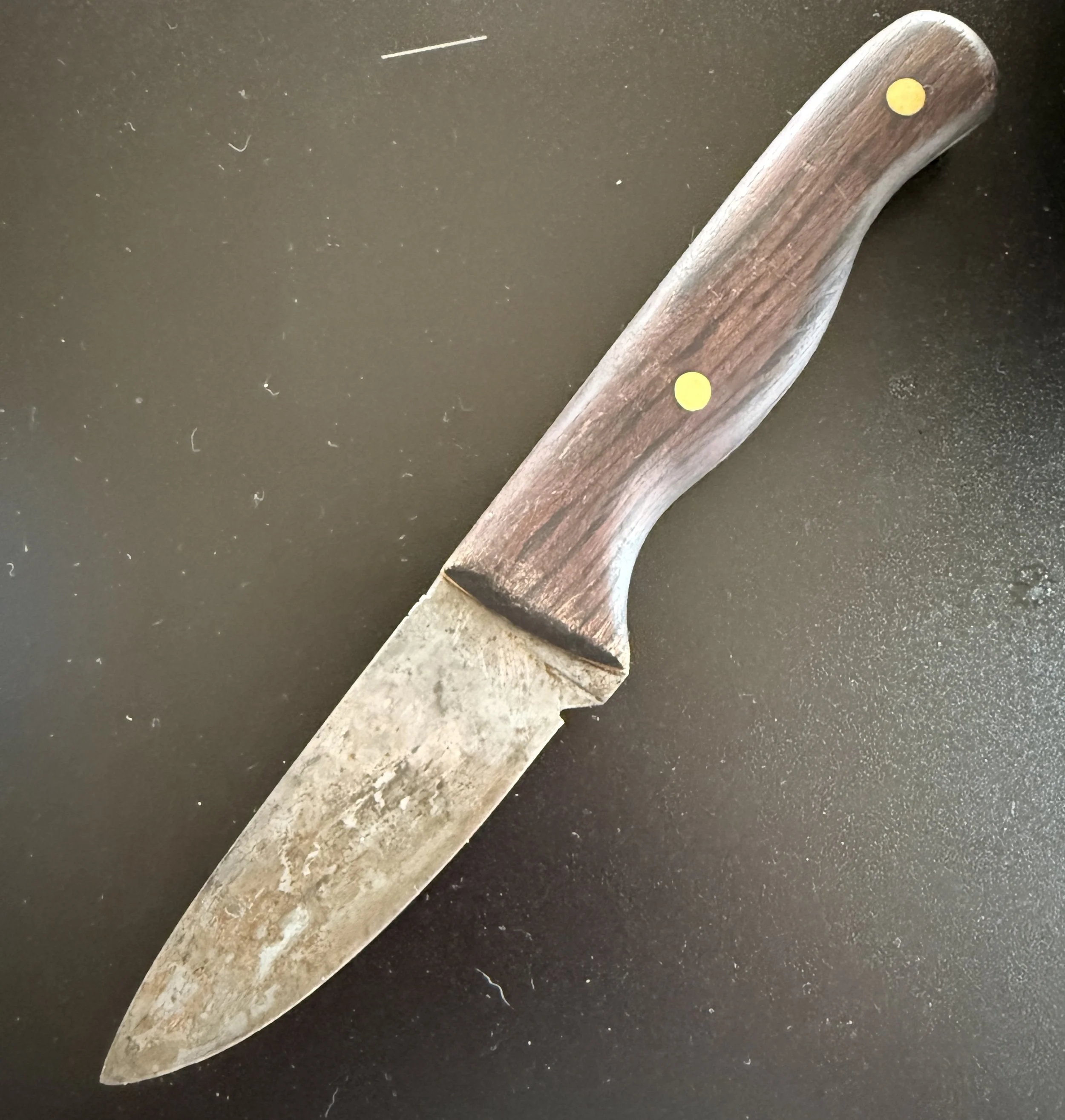 Early handmade 1080 carbon steel knife showing a well-developed working patina.
