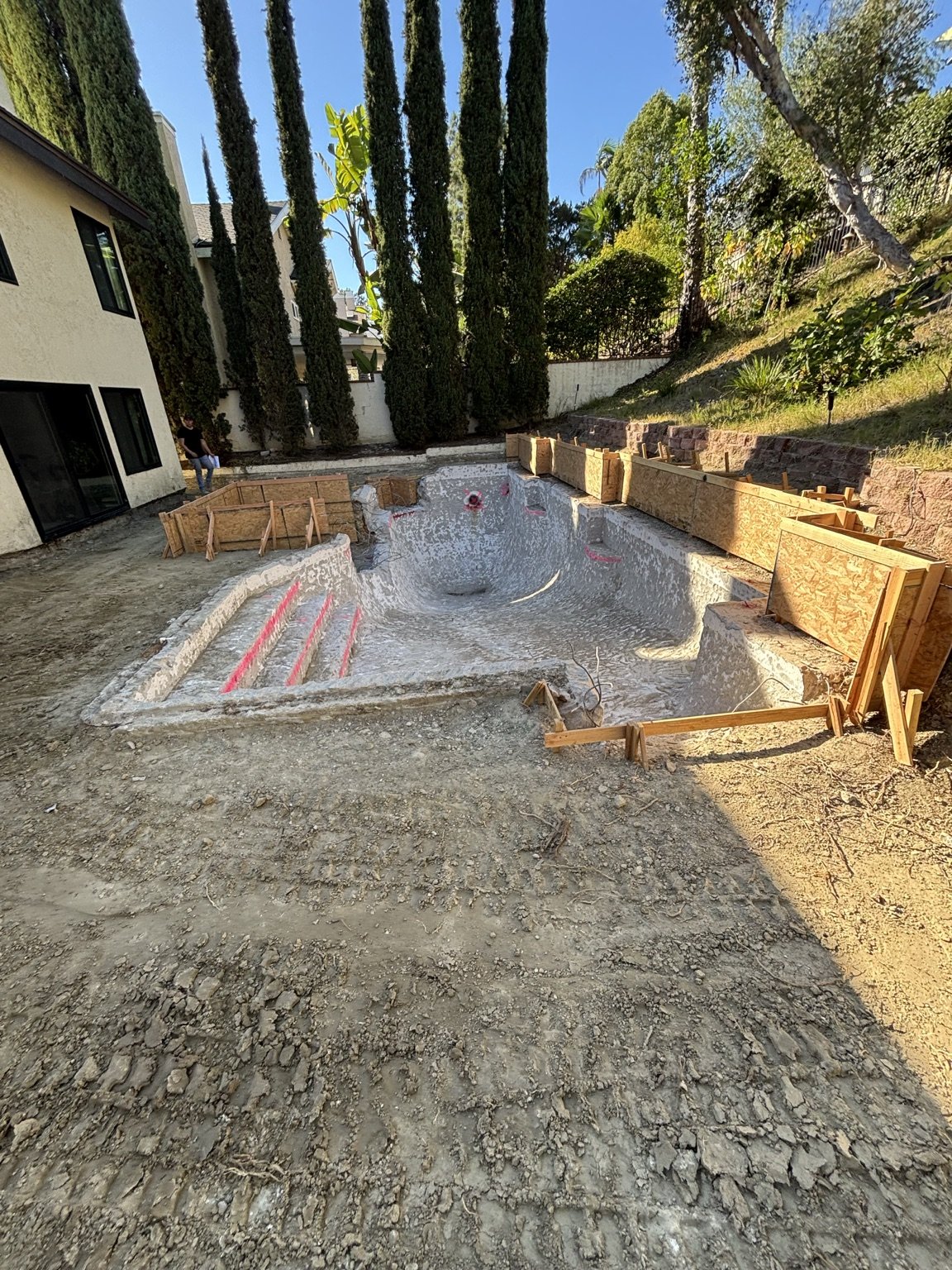 Complete backyard and swimming pool structural remodel in progress with custom forming