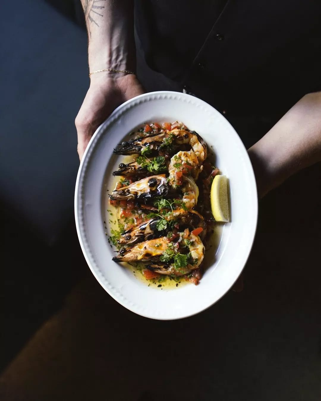 Mooloolaba king prawns grilled over wood fire, served with bright sauce vierge.