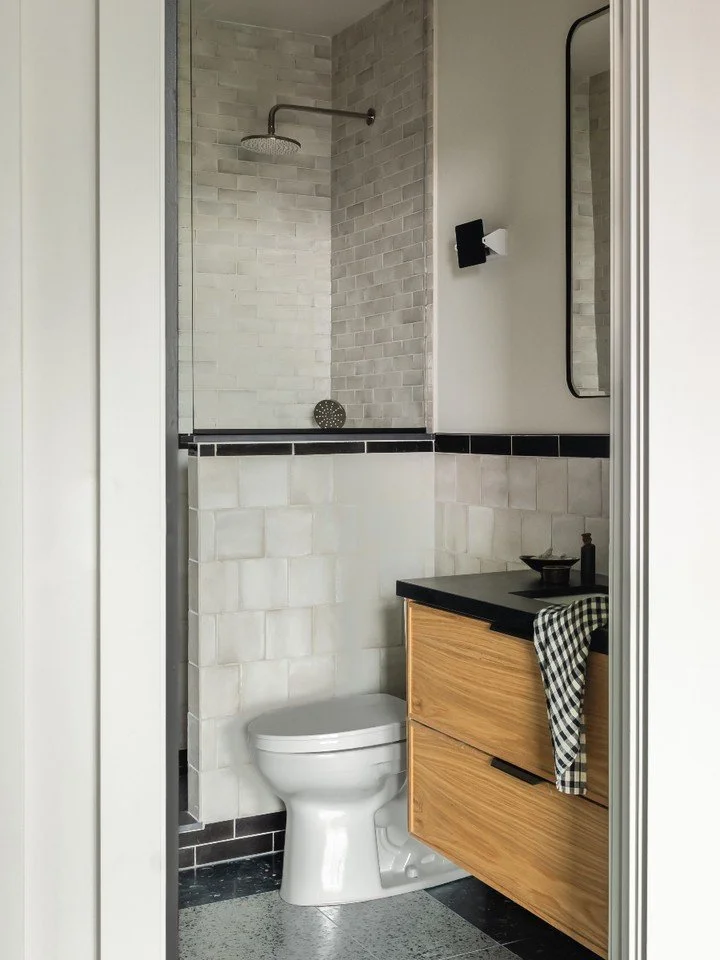 I'm trying to have a strict no toilet bowls in photos rule but sometimes design reality wins. So instead, let&rsquo;s shift focus to what does matter: the materiality. The floor tile is a muted terrazzo that grounds the space, while the shower walls 