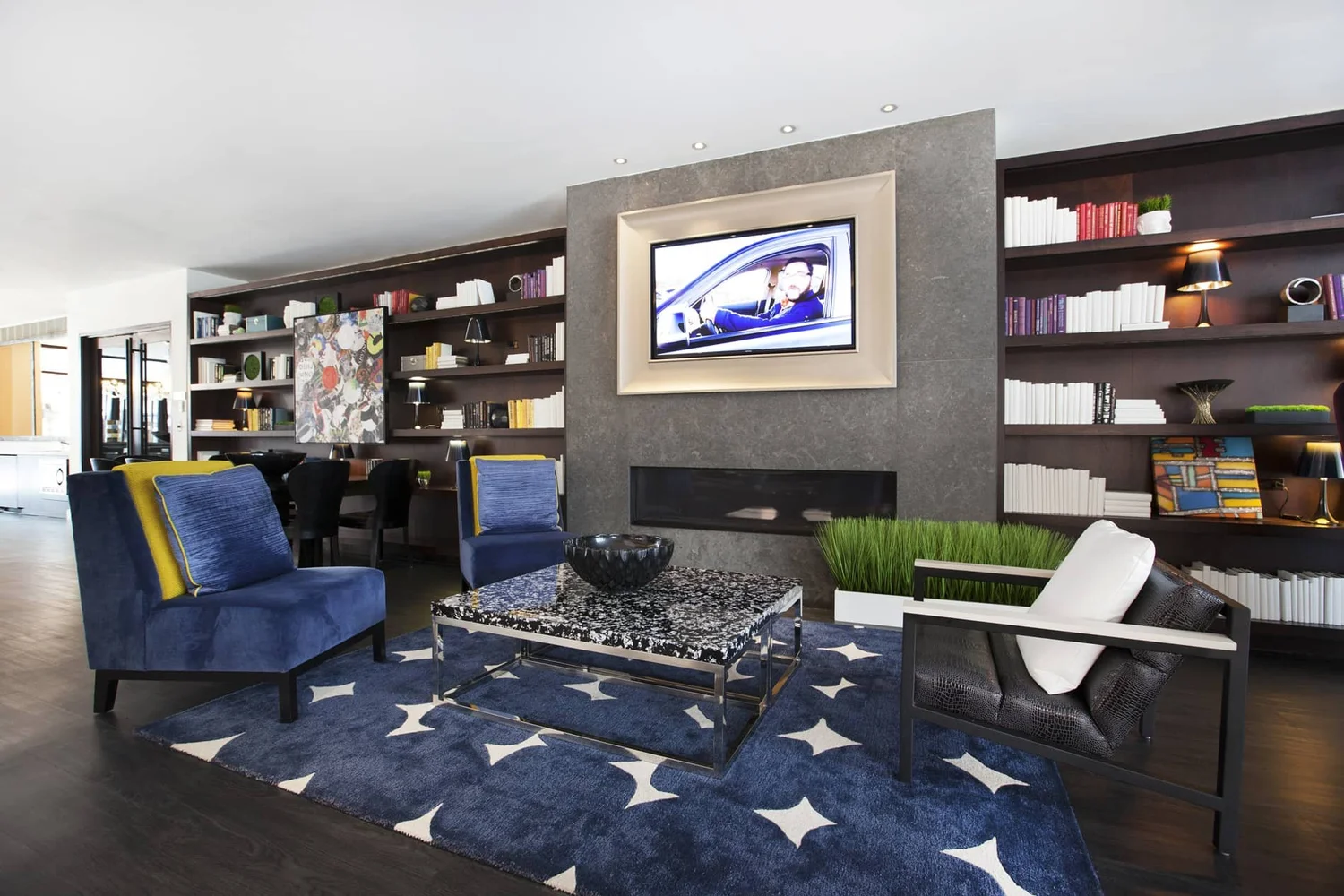 Lounge with fireplace and bookshelves