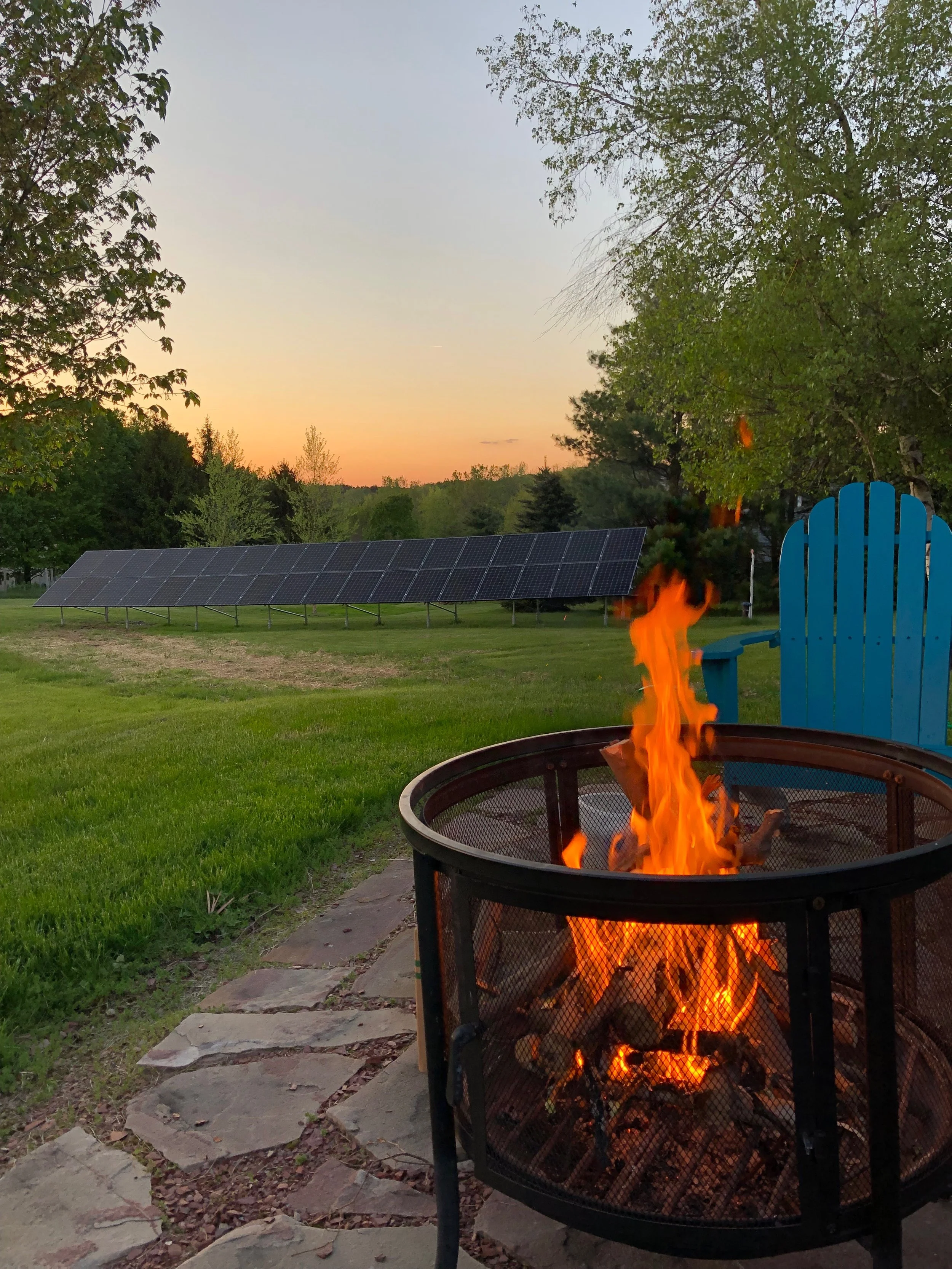 Ground mounted solar in a yard with a campfire