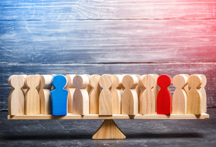 wooden block people on a scale