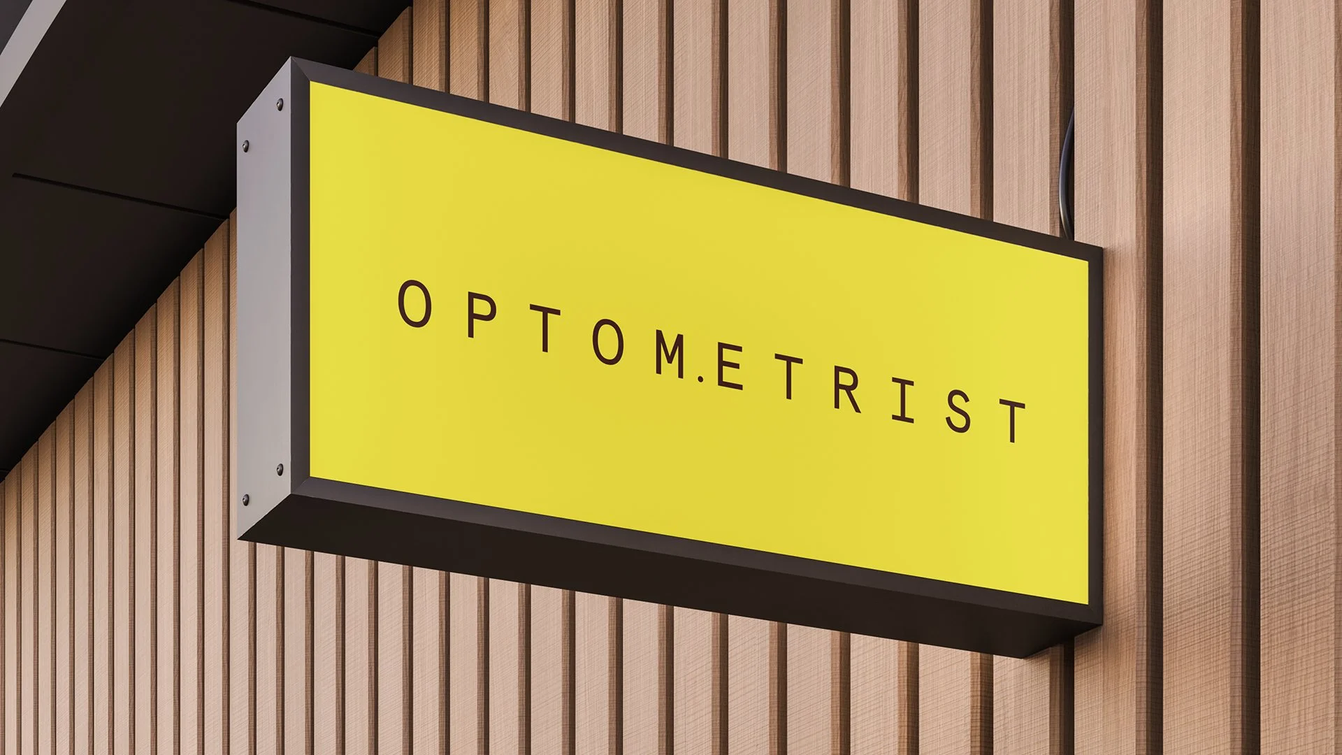 Yellow illuminated sign with black border reading 'OPTOMETRIST' mounted on a wooden wall.