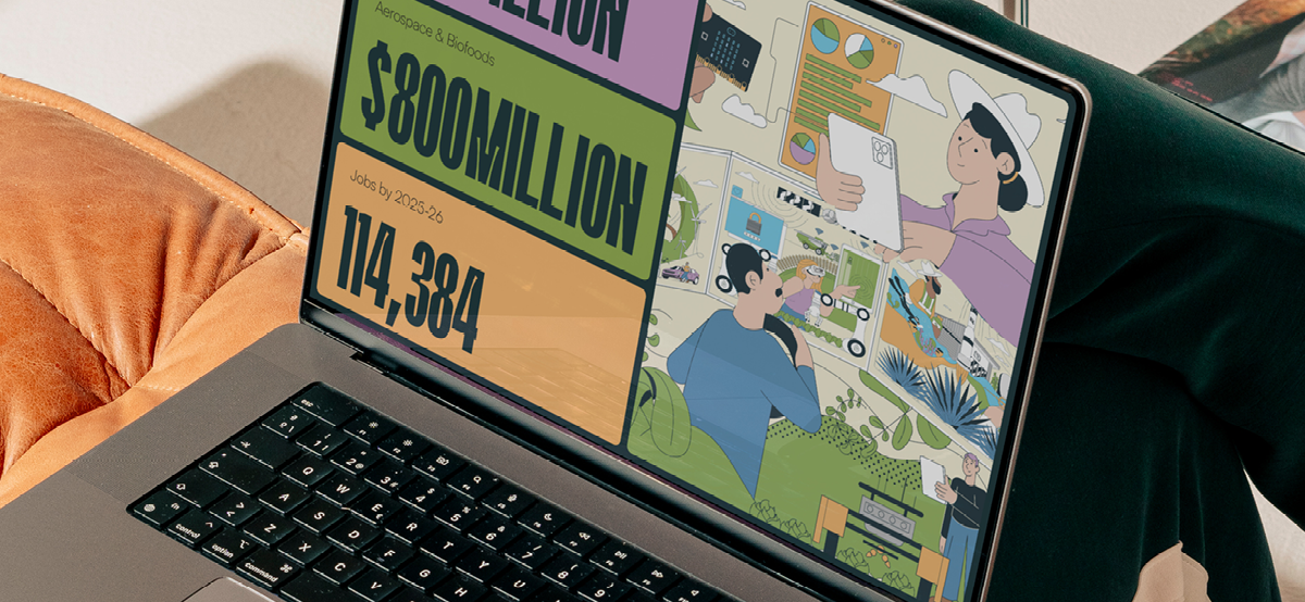 Greater Whitsunday Alliance digital design displayed on a laptop, combining economic statistics with colourful illustrations.