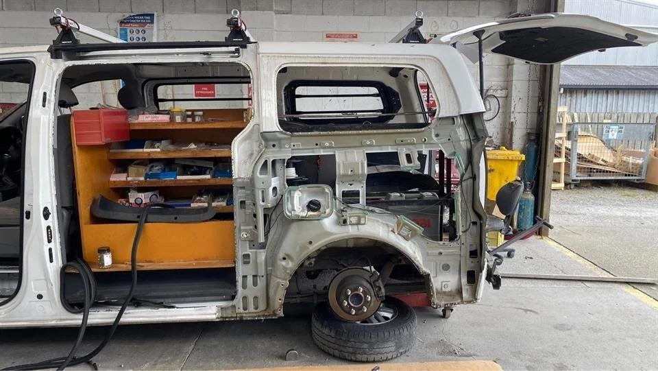 Partially dismantled van being repaired in workshop