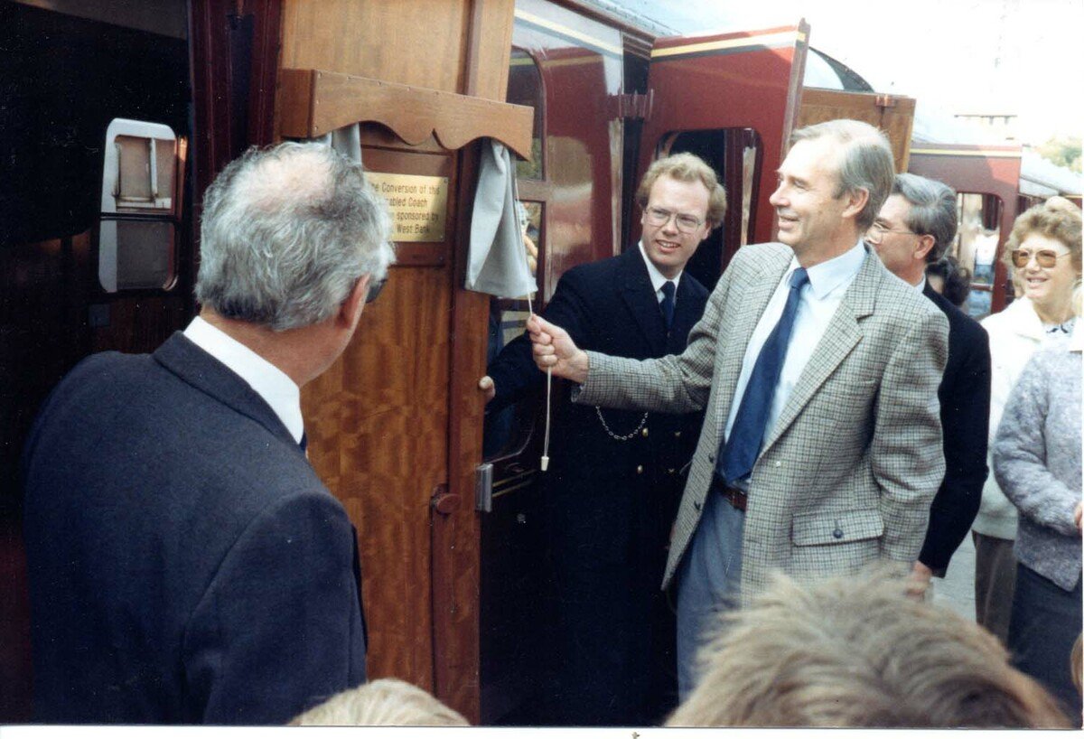 A representative of NatWest bank unveils a plaque following the completion of the conversion to a disabled access coach. ©D Cole