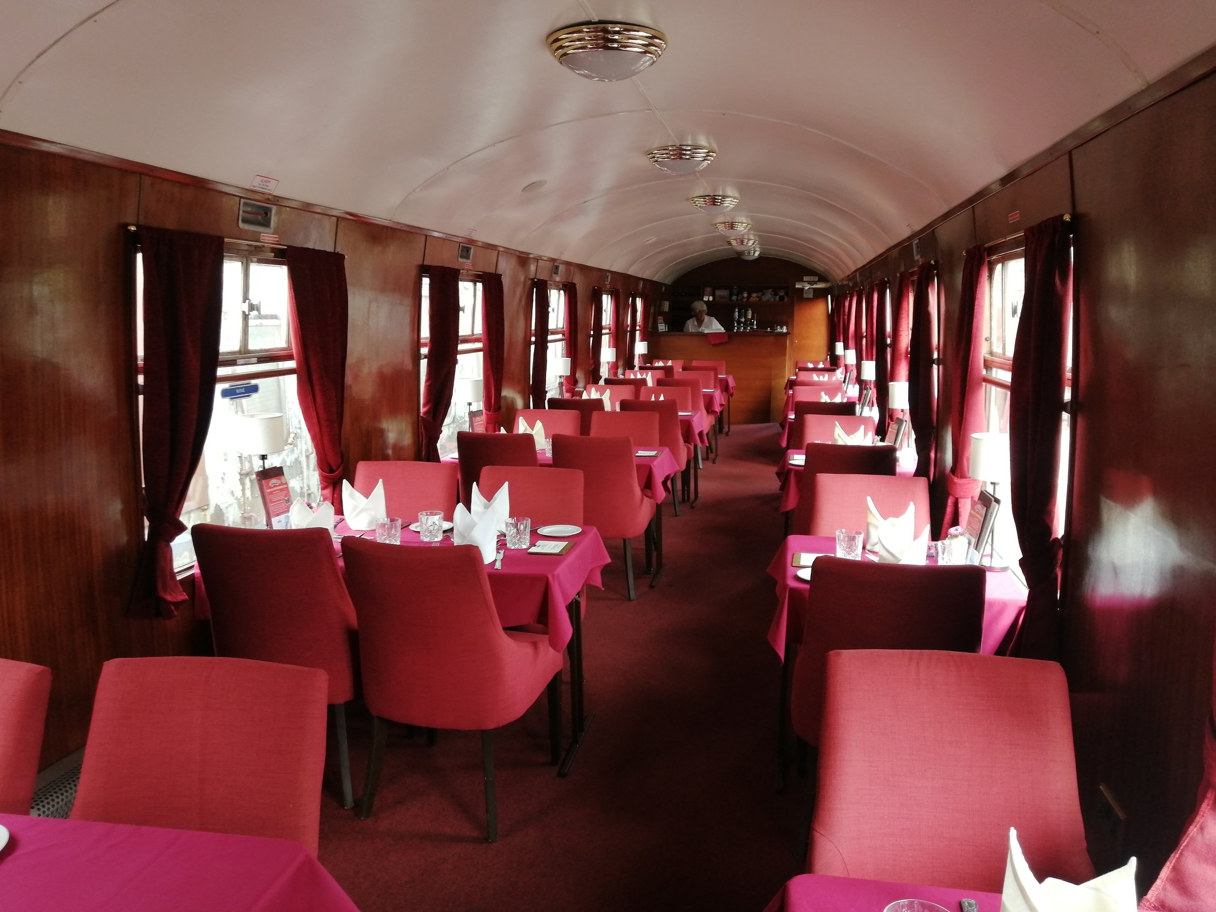 The interior of the carriage with the tables laid out for a Bitton Belle dining train.