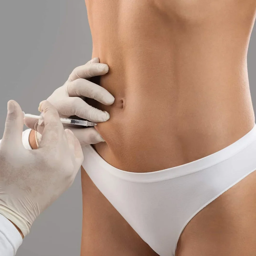 Person writing with a pen in a notebook on a desk near a window.