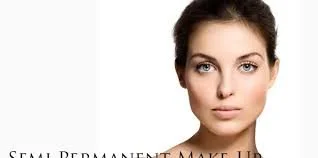 Close-up of a woman with clear skin and dark hair, looking directly at the camera