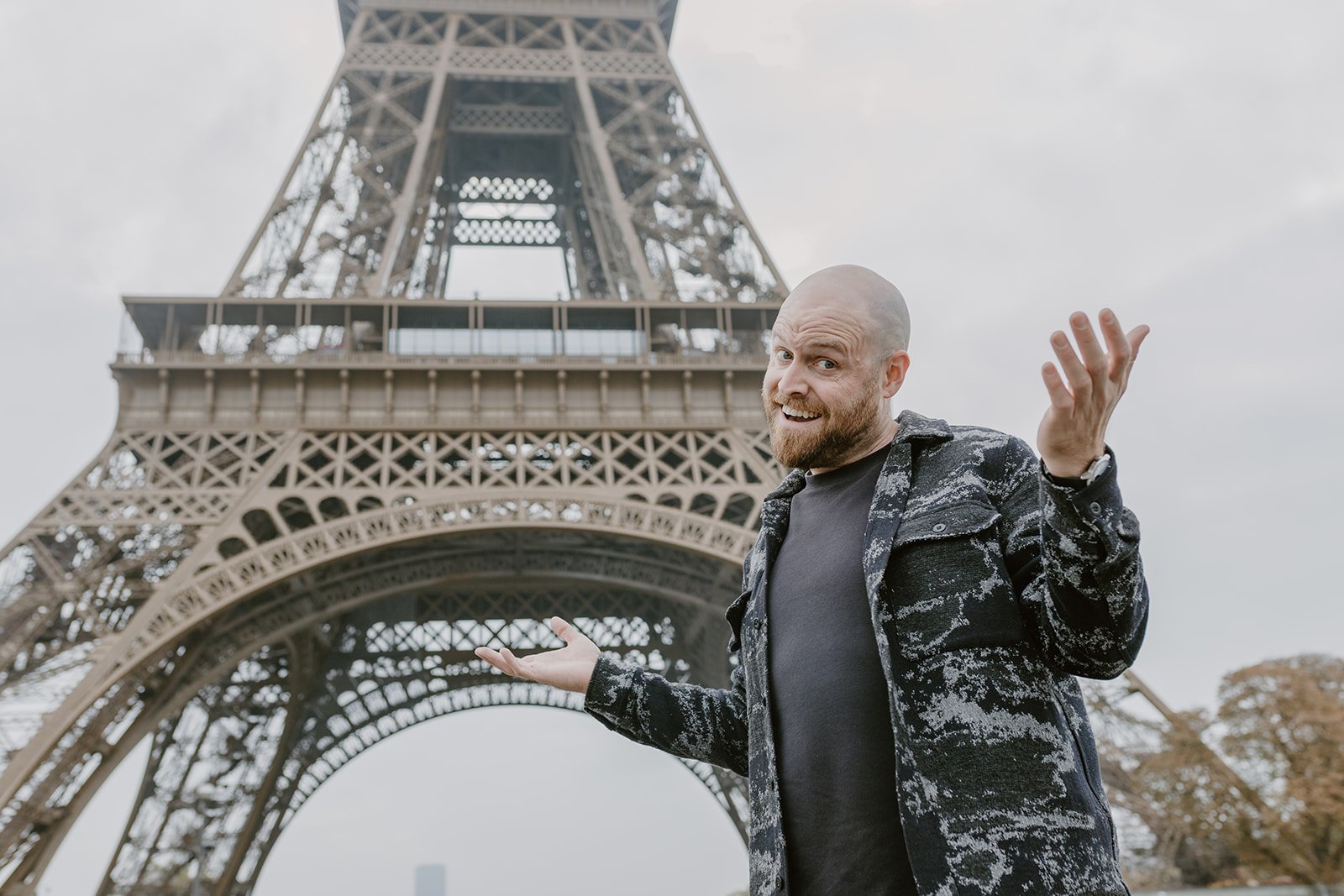 Jay Swanson standing in front of the Eiffel Tower