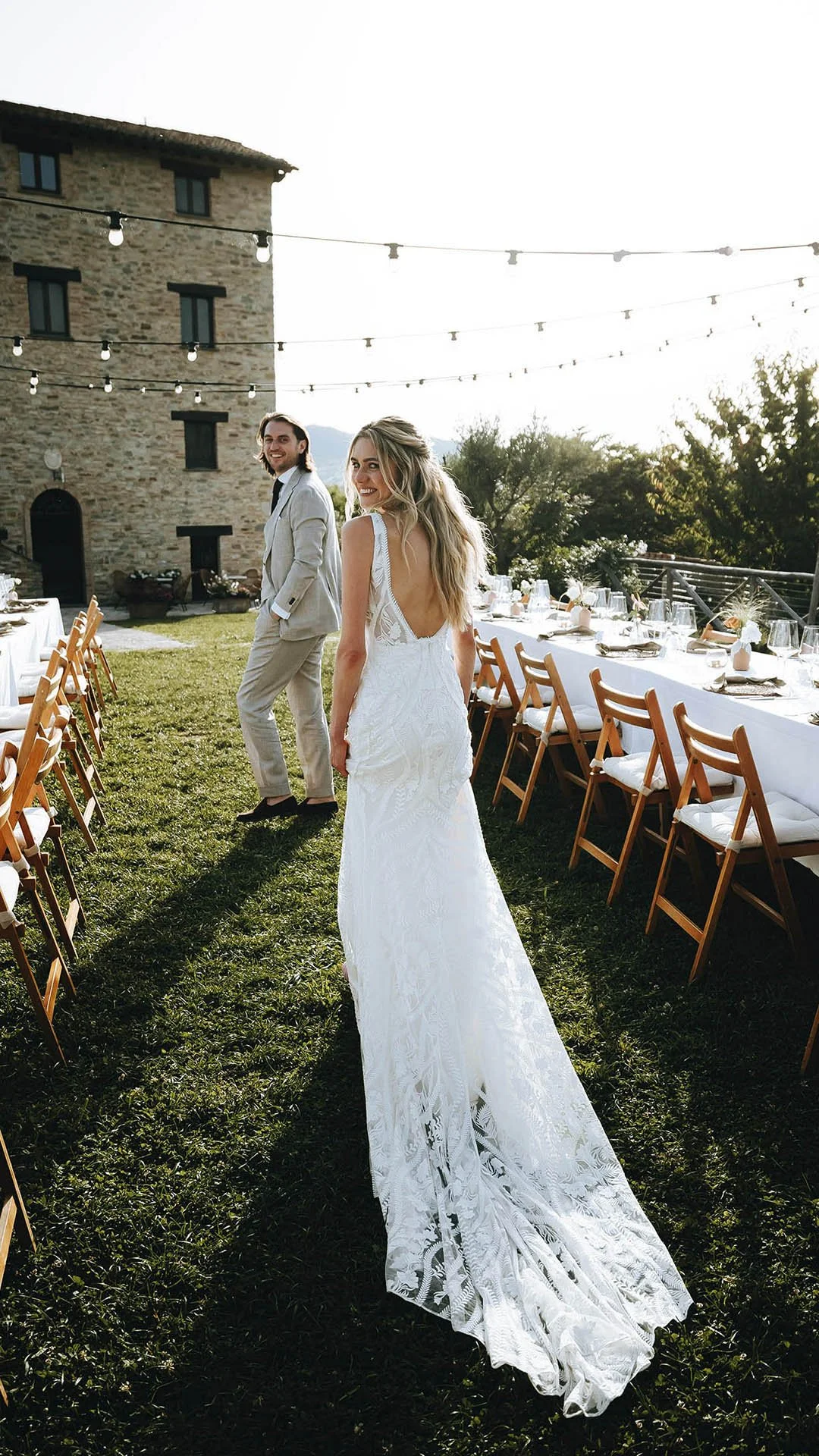 bride and groom walking together through the dinner tables