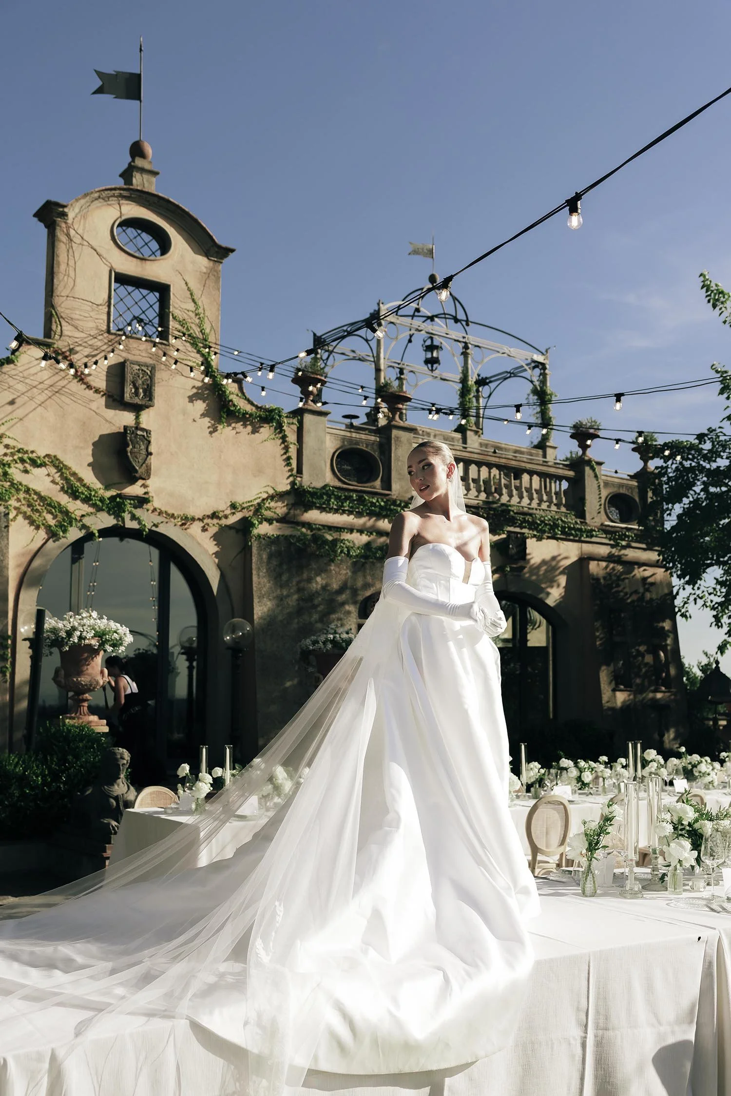 the bride standing on top of the dinner table ready for the guests to arrive at Tenuta Corbinaia