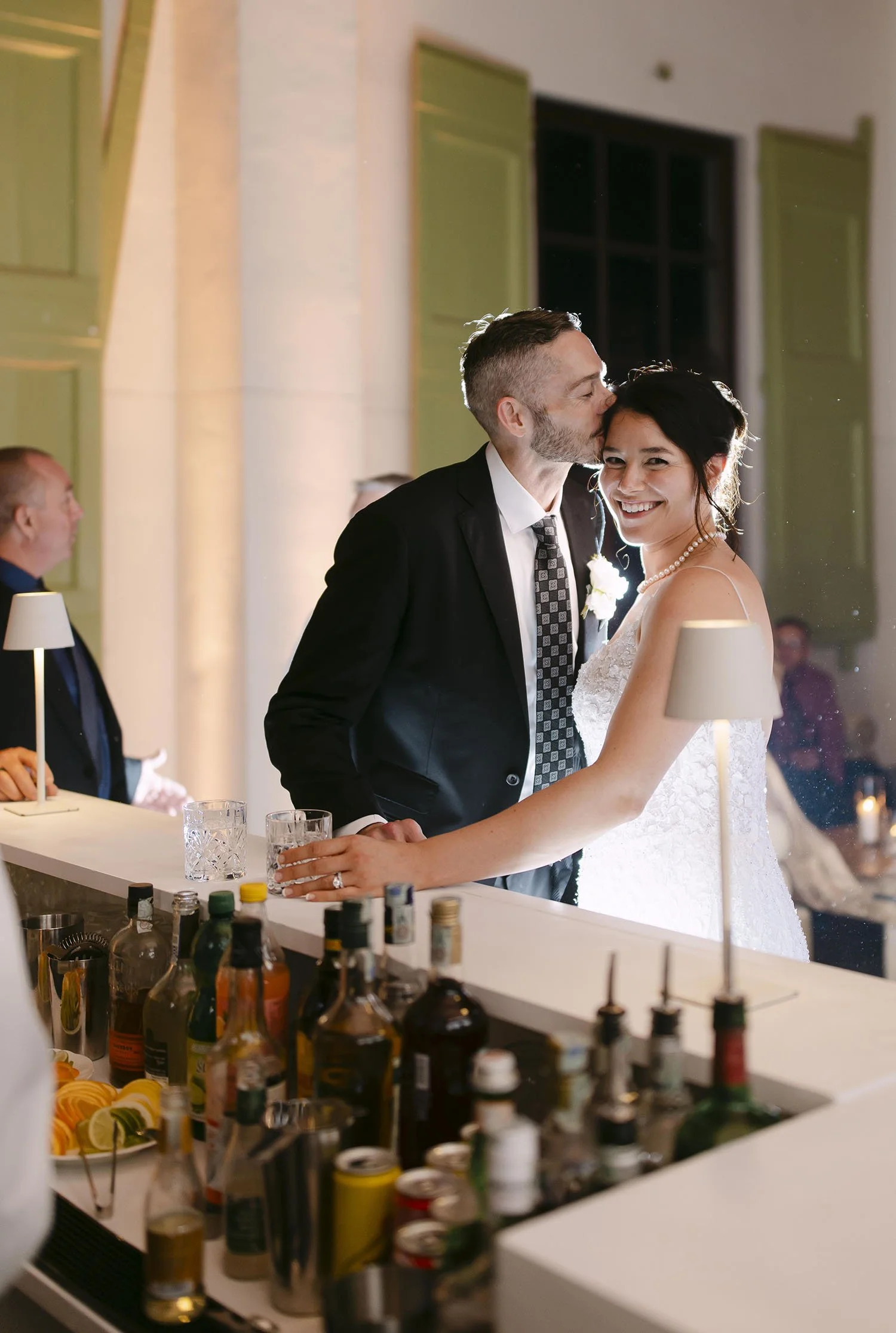 Groom kiss the bride at the bar during the party