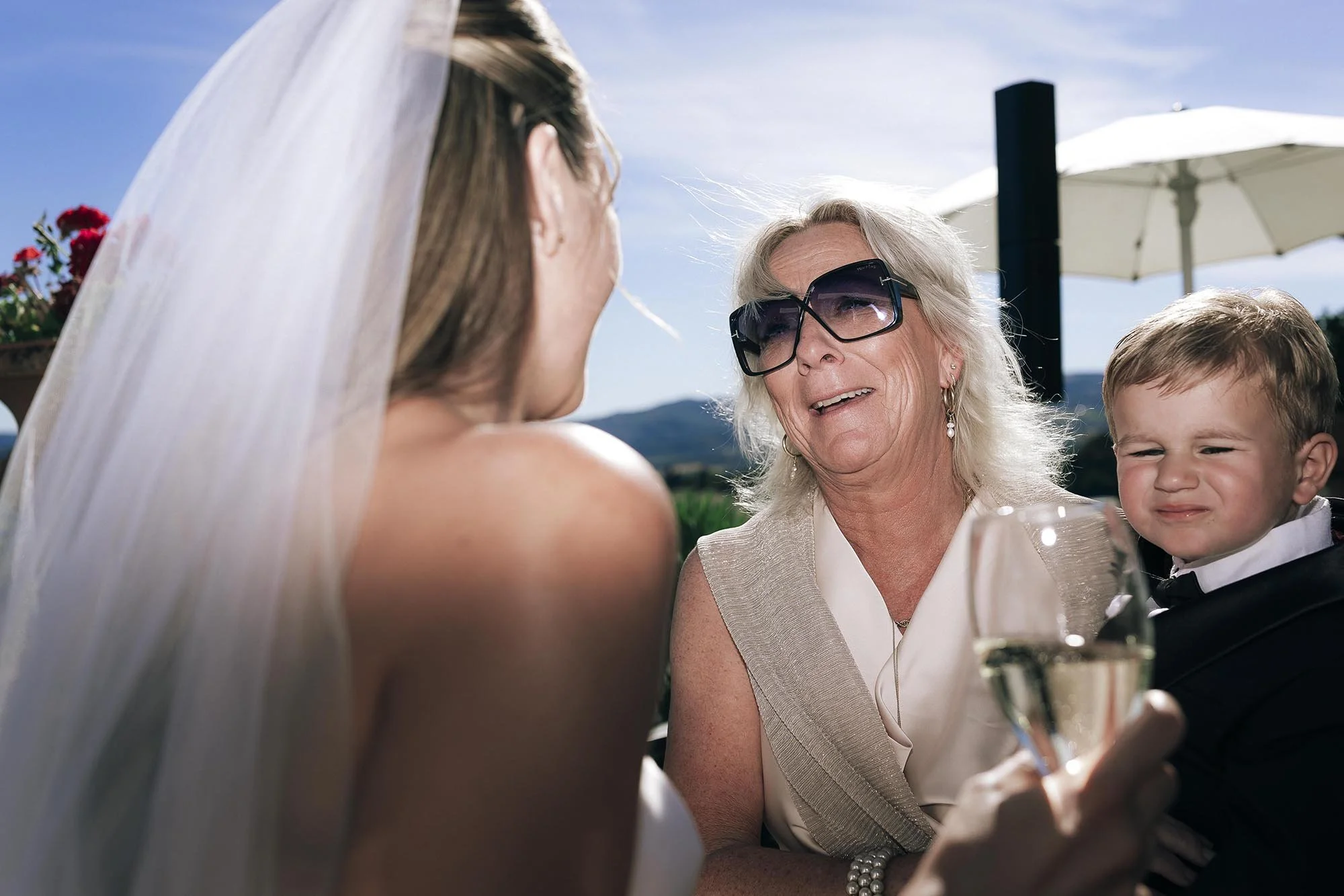 guests celebrating the couple kissing and holding them