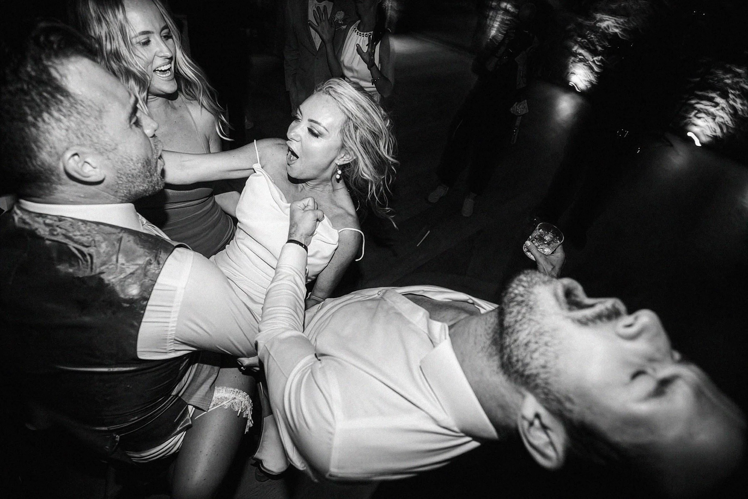 bride and groom dancing with their friends