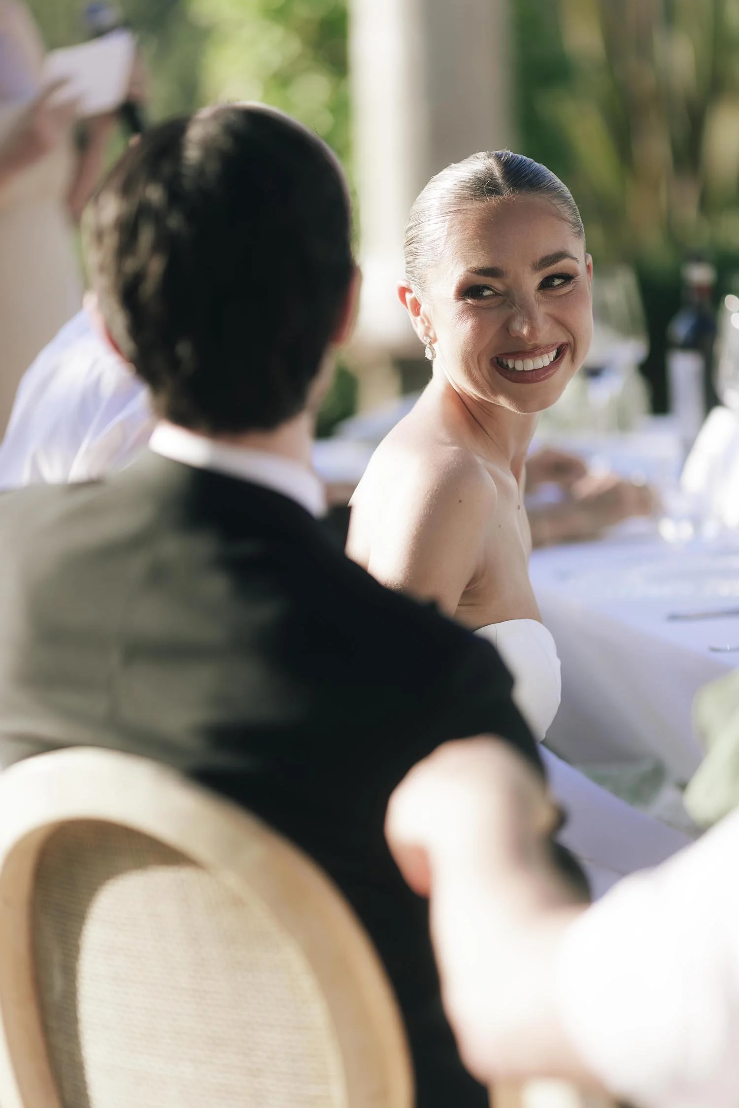 Bride looking happily the groom during the speeches