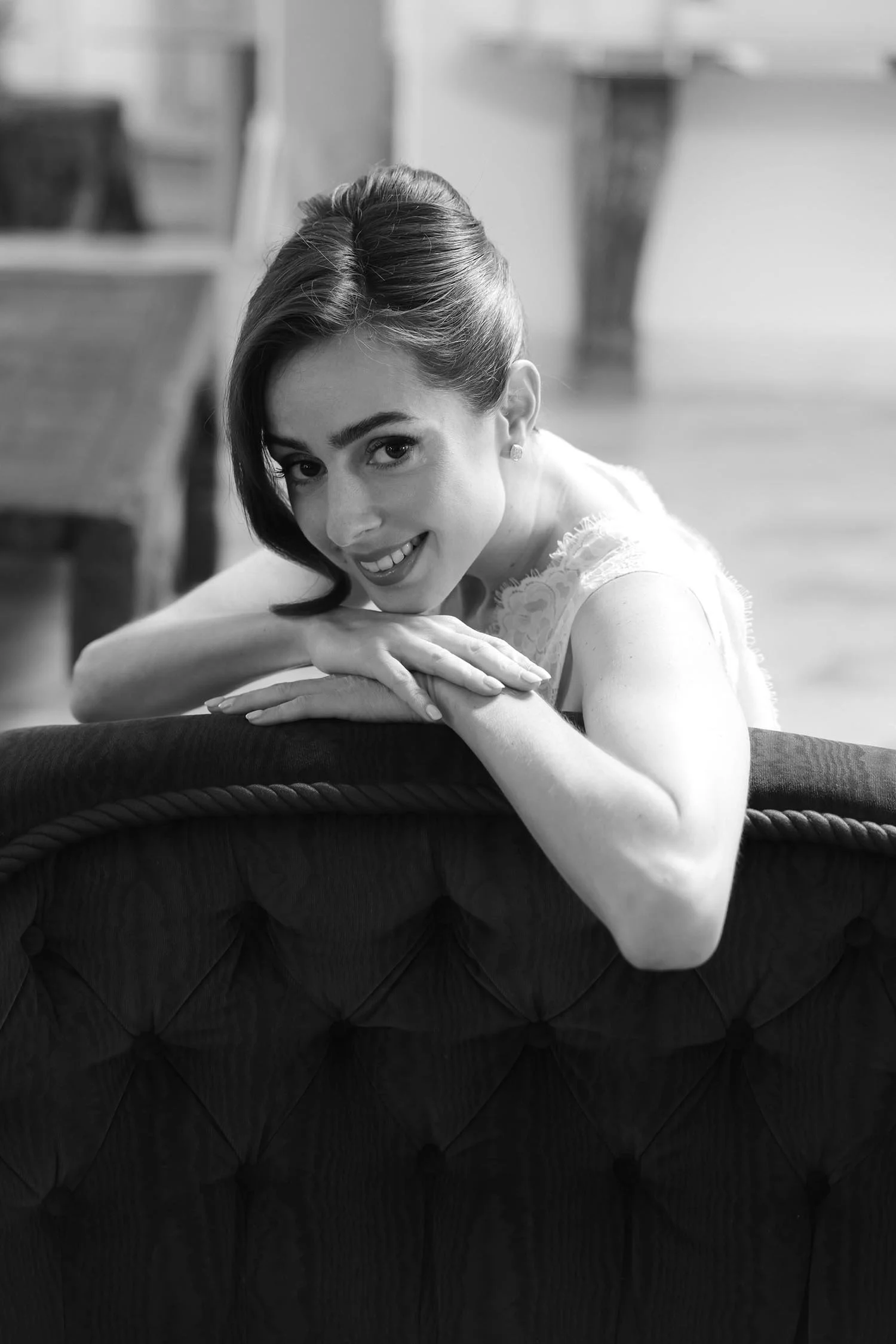 bride sitting on the sofa and smiling to the camera at Tenuta Corbinaia
