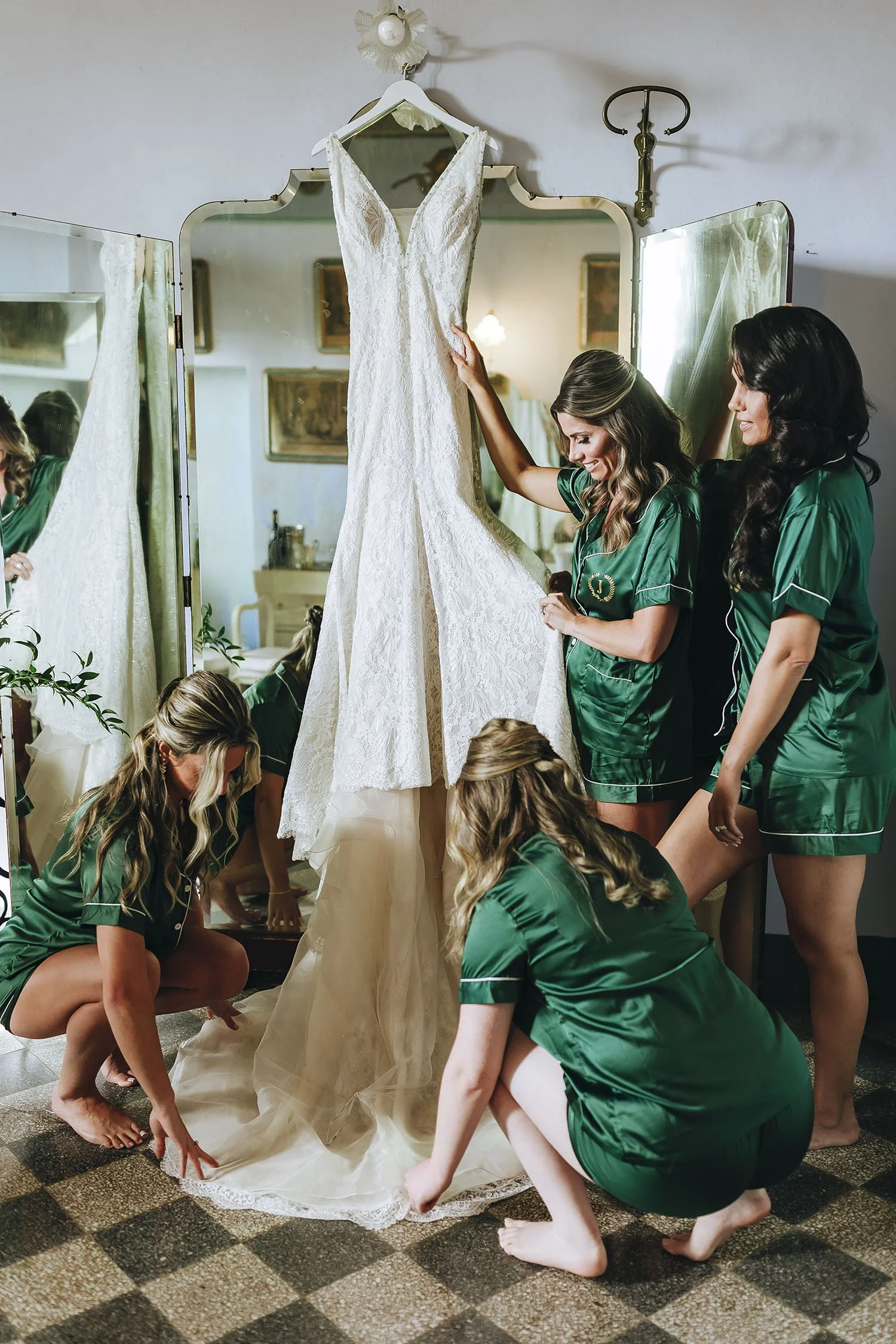 bridesmaids checking the dress hanging in the restroom