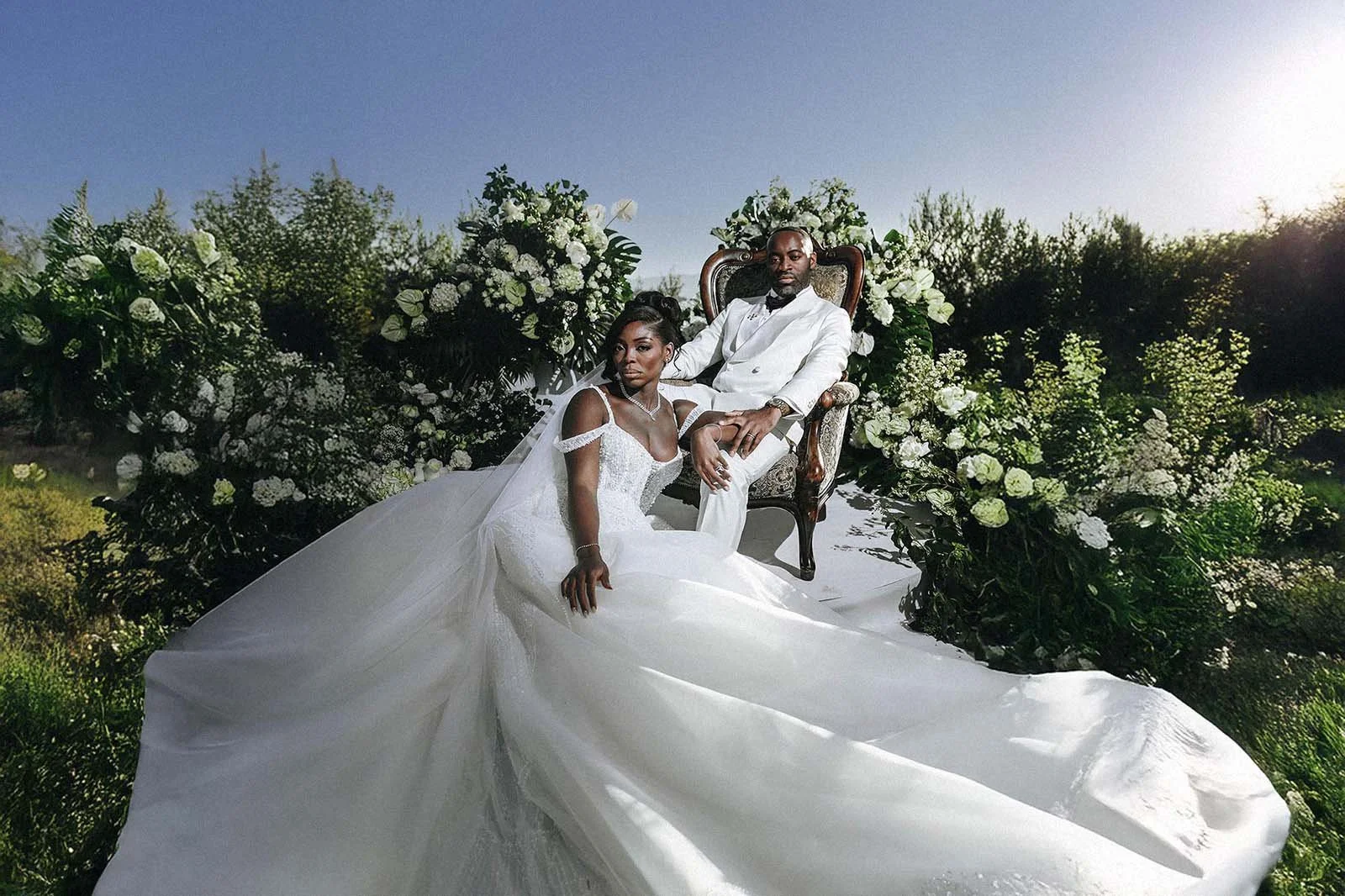 bride and groom posing in the garden of Castello di Petrata for an editorial magazine oriented portrait