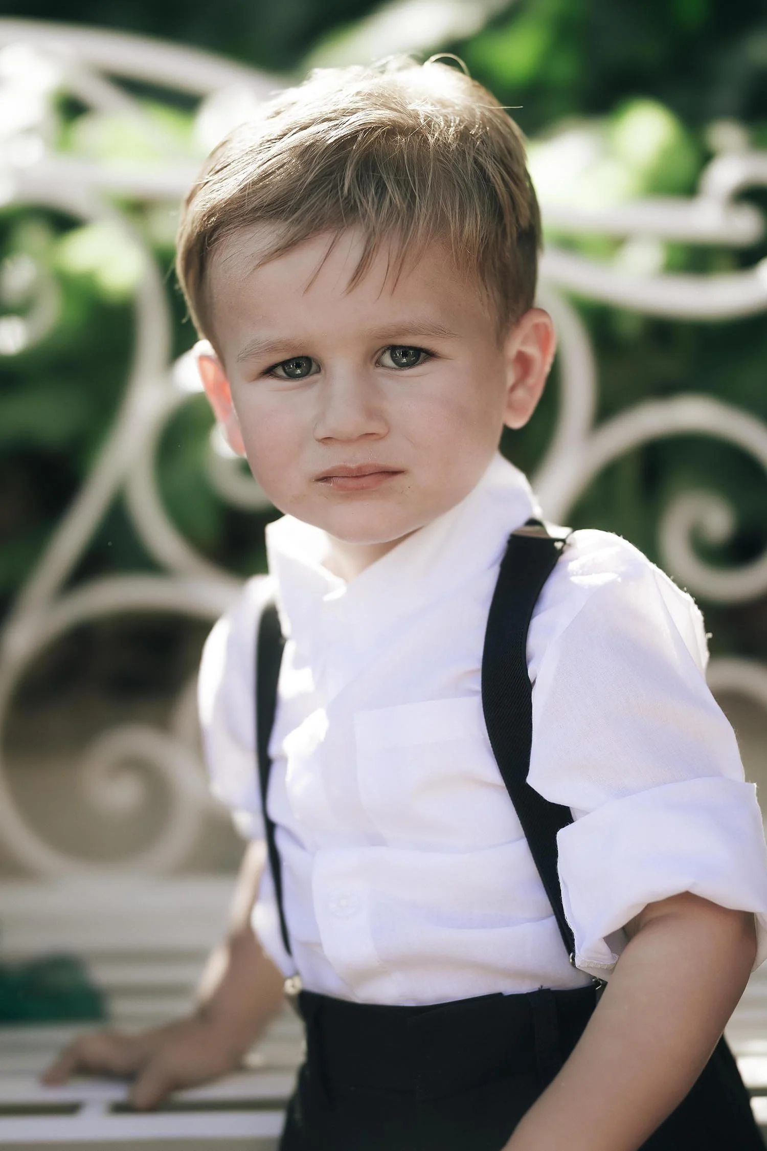 portrait of the son of the bride in white shirt