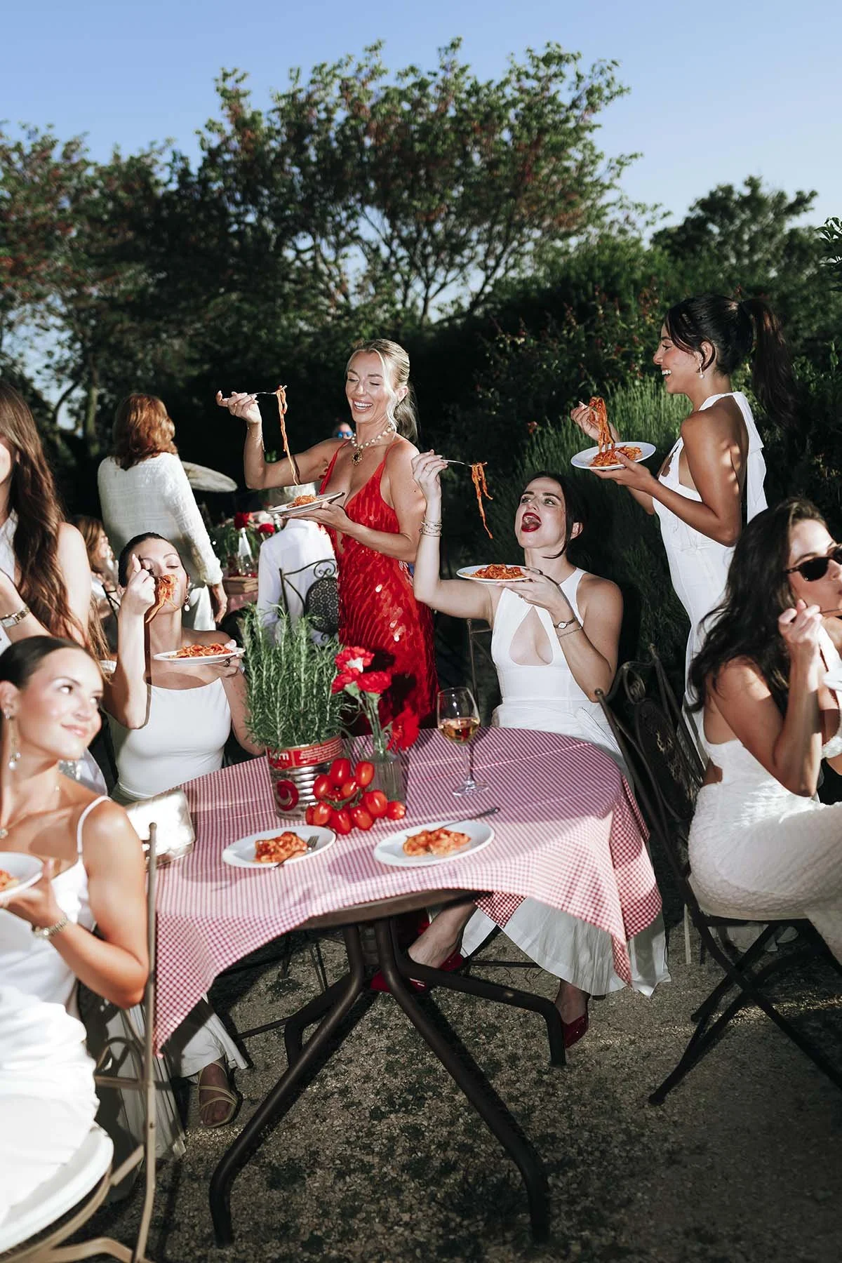 bride and bridesmaids eating pasta