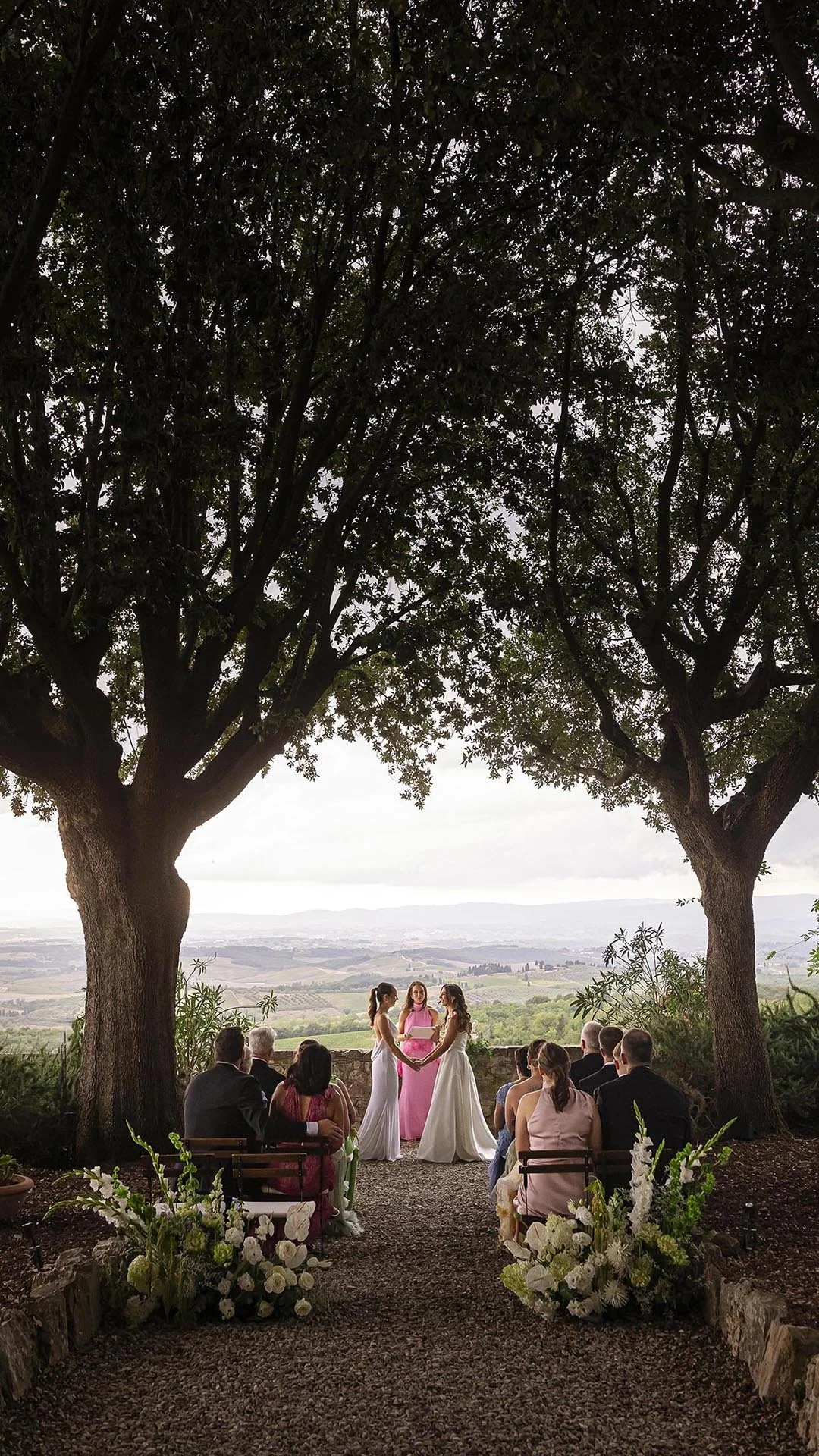Same sex wedding of two brides with a celebration overlooking Chianti hills