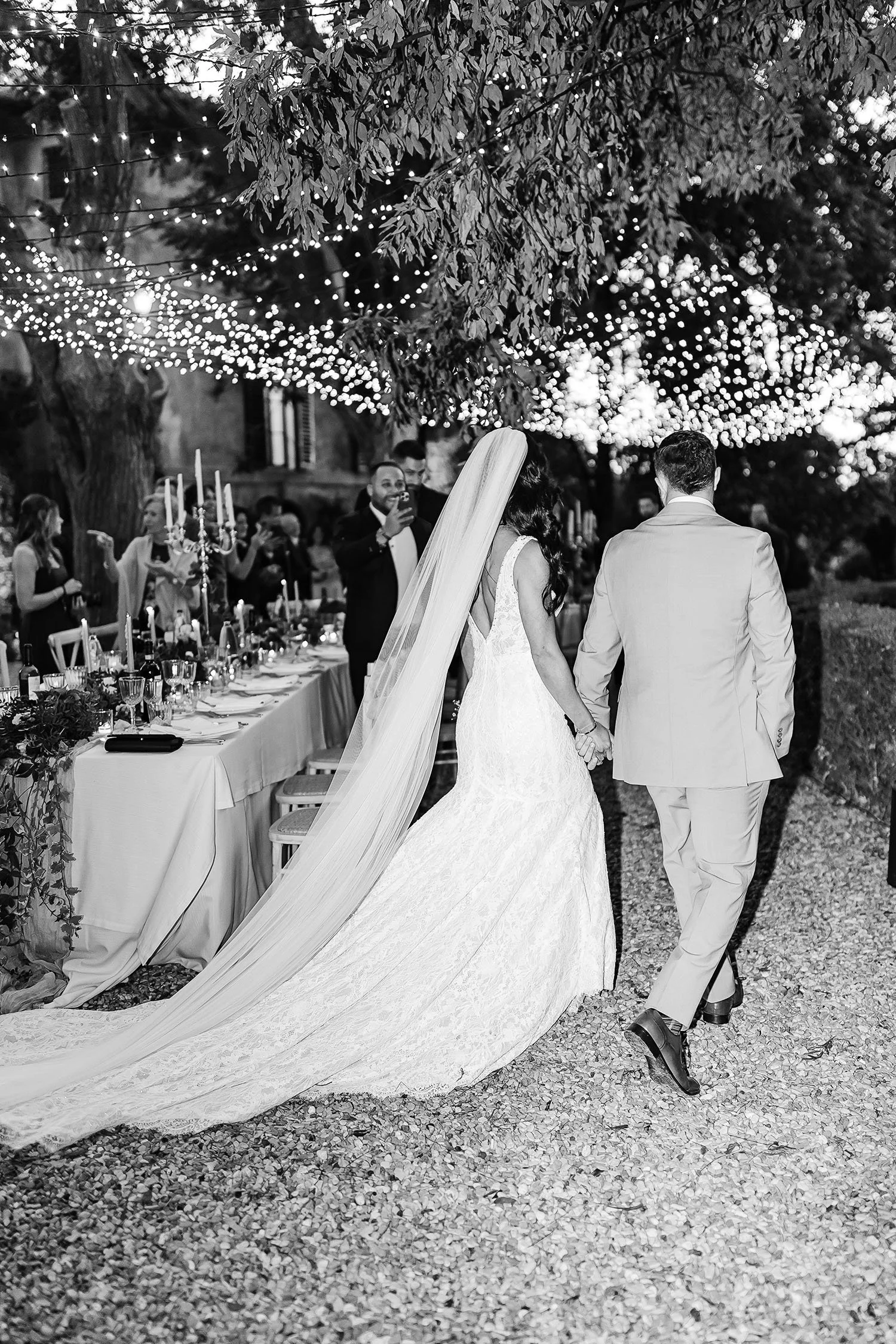bride and groom walking to the dinner tables