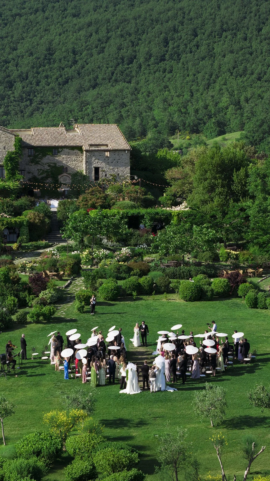 aerial view of the ceremony setting with the bride walking down the aisle with her father